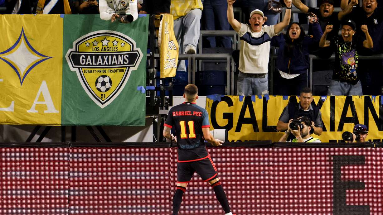Los Angeles Galaxy supporters cheer as Los Angeles Galaxy's Gabriel Pec (11) celebrates his goal against the Vancouver Whitecaps during the first half of an MLS soccer match Saturday, Sept. 21, 2024, in Carson, Calif.