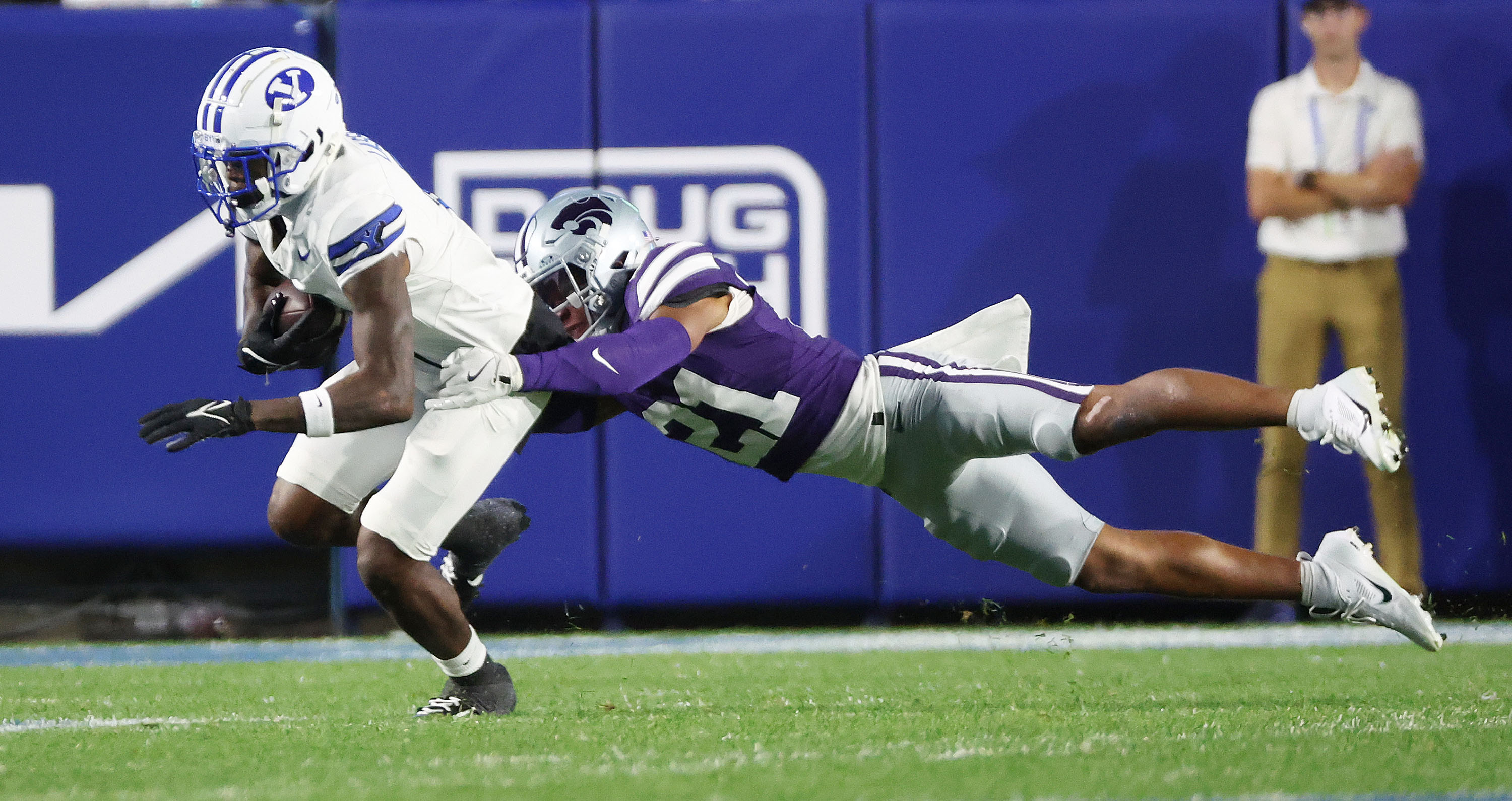 Brigham Young wide receiver Darius Lassiter (5) runs after a catch against Kansas State safety Marques Sigle (21) in Provo on Saturday, Sept. 21, 2024. BYU won 38-9.