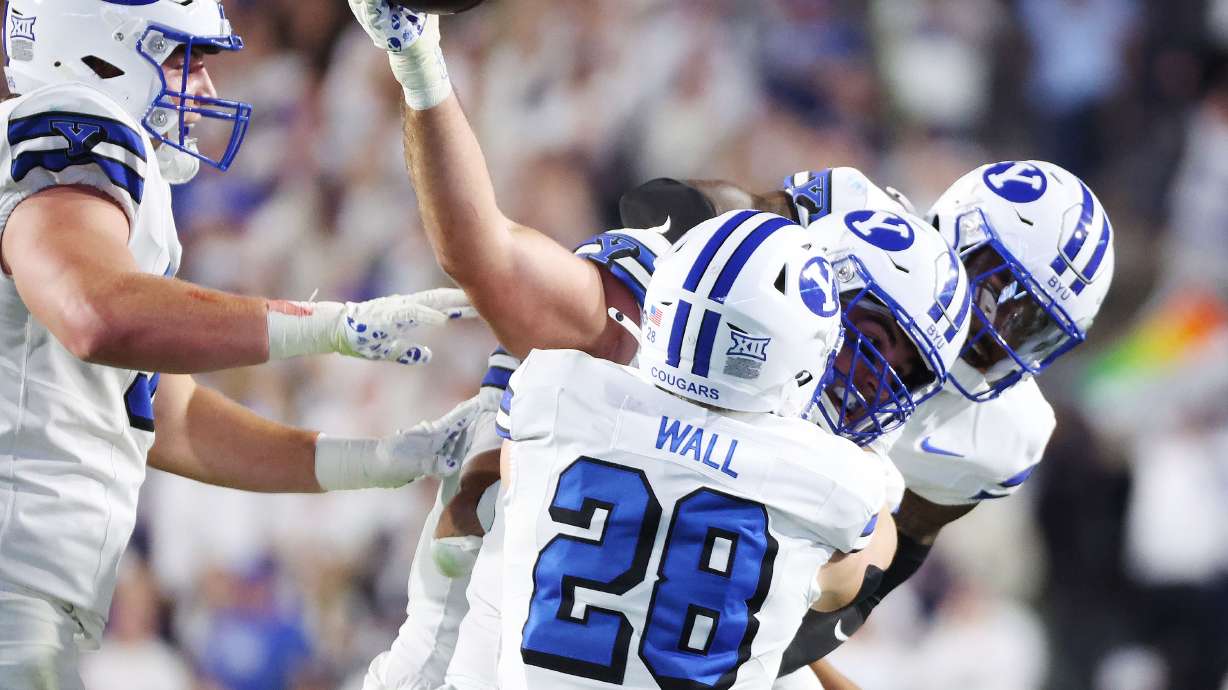 Brigham Young Cougars defensive end Tyler Batty (92) celebrates his interception again Kansas State Wildcats in Provo on Saturday, Sept. 21, 2024.