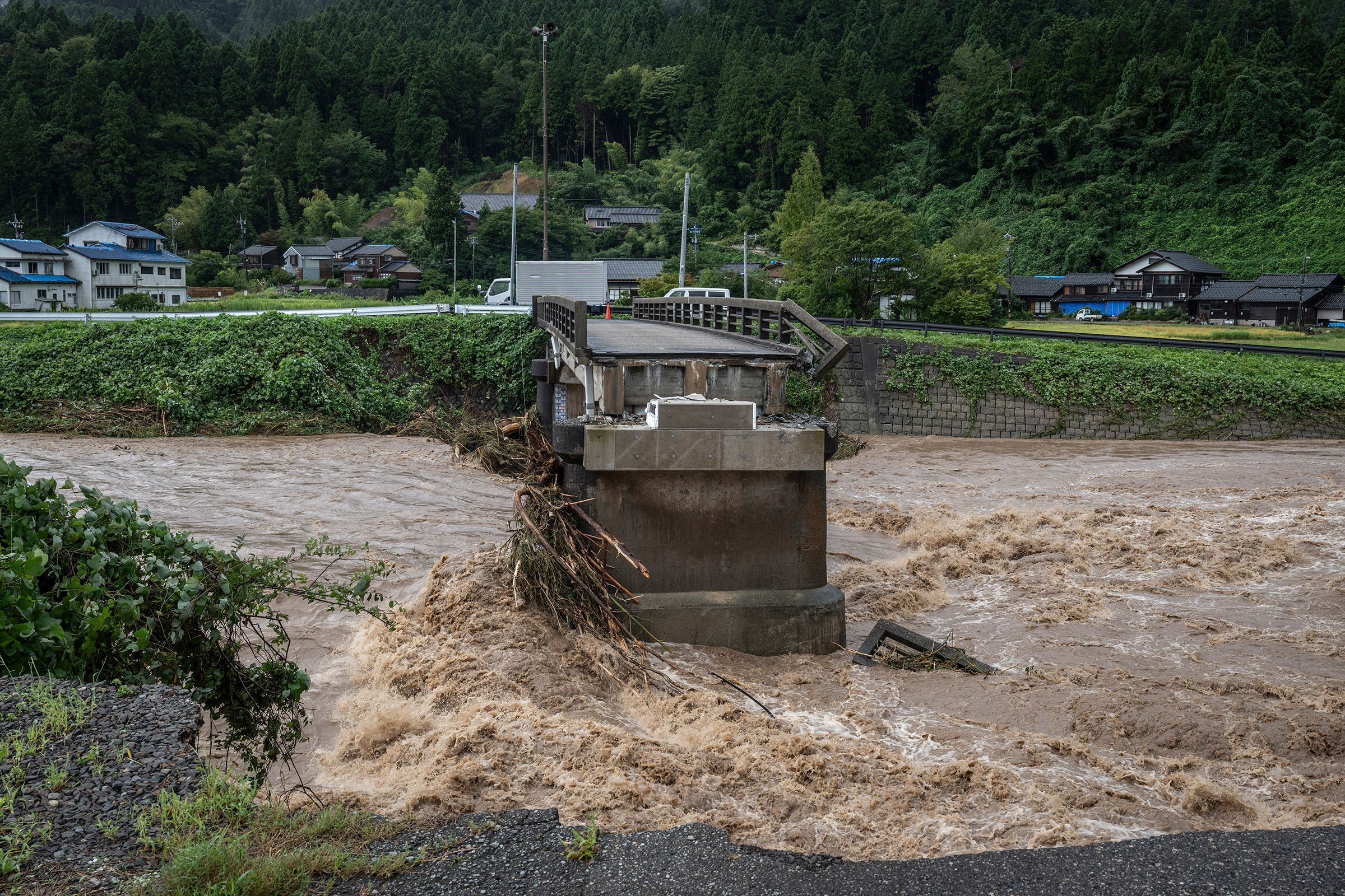 Japan region still recovering from deadly earthquake. Now record rains have flooded its streets