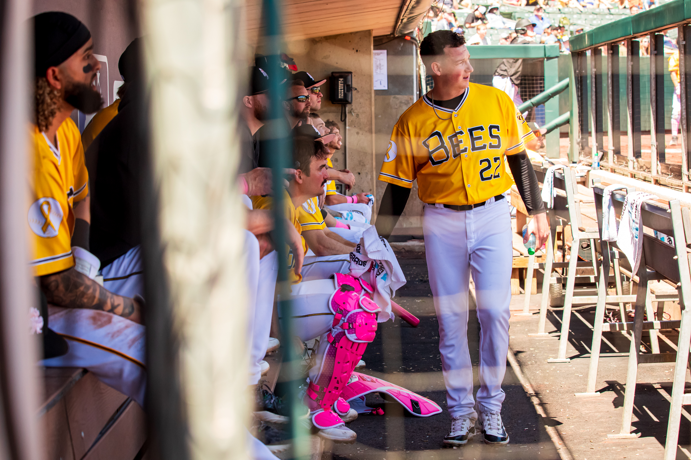 Salt Lake Bees pitcher Kenny Rosenberg, right, watches a Bees at-bat while walking around the Smith's Ballpark dugout on May 12.