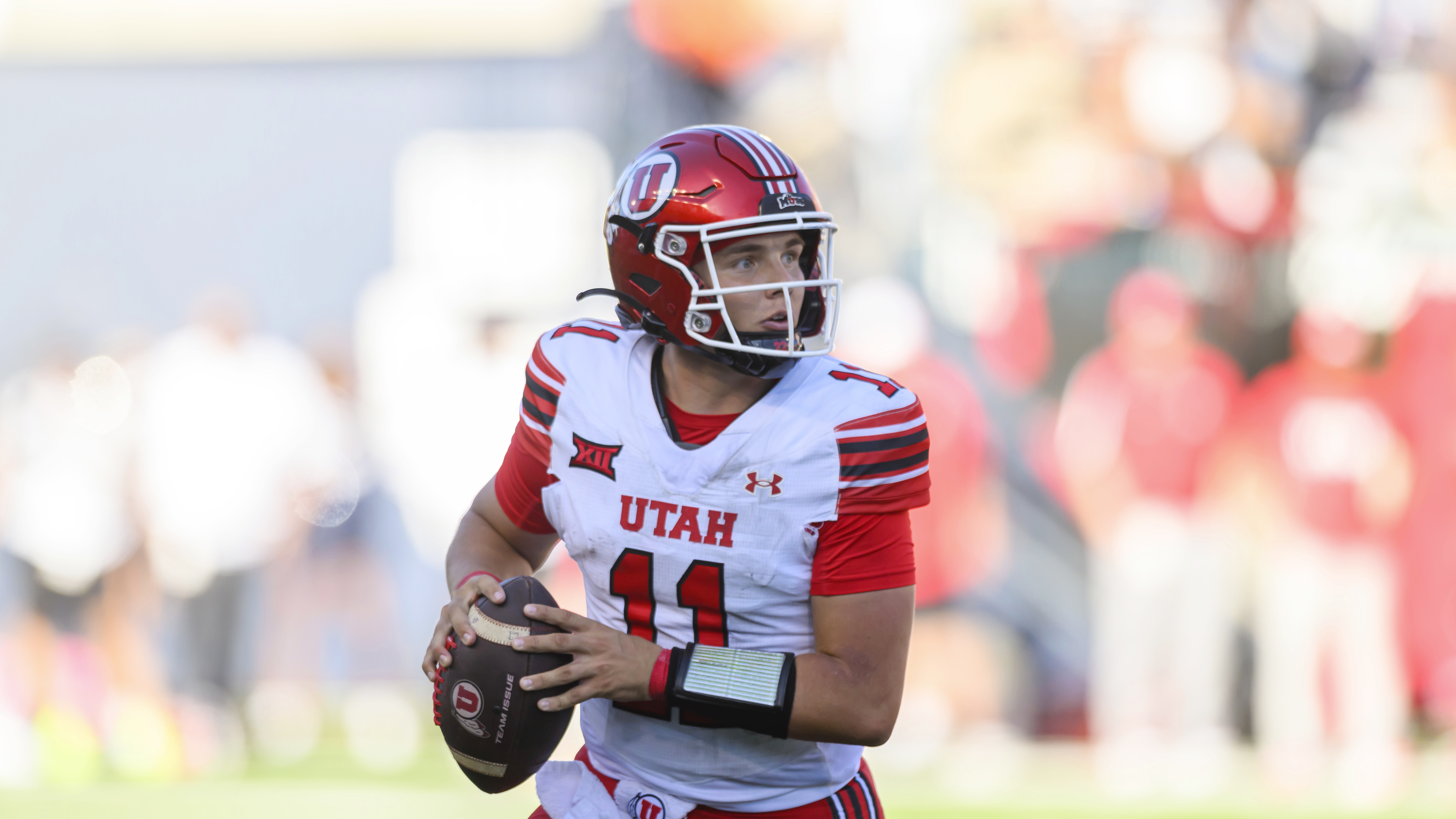 Utah quarterback Isaac Wilson (11) runs out of the pocket from defensive pressure looking to throw the football during an NCAA football game on Saturday, Sept. 14, 2024 in Logan, Utah.