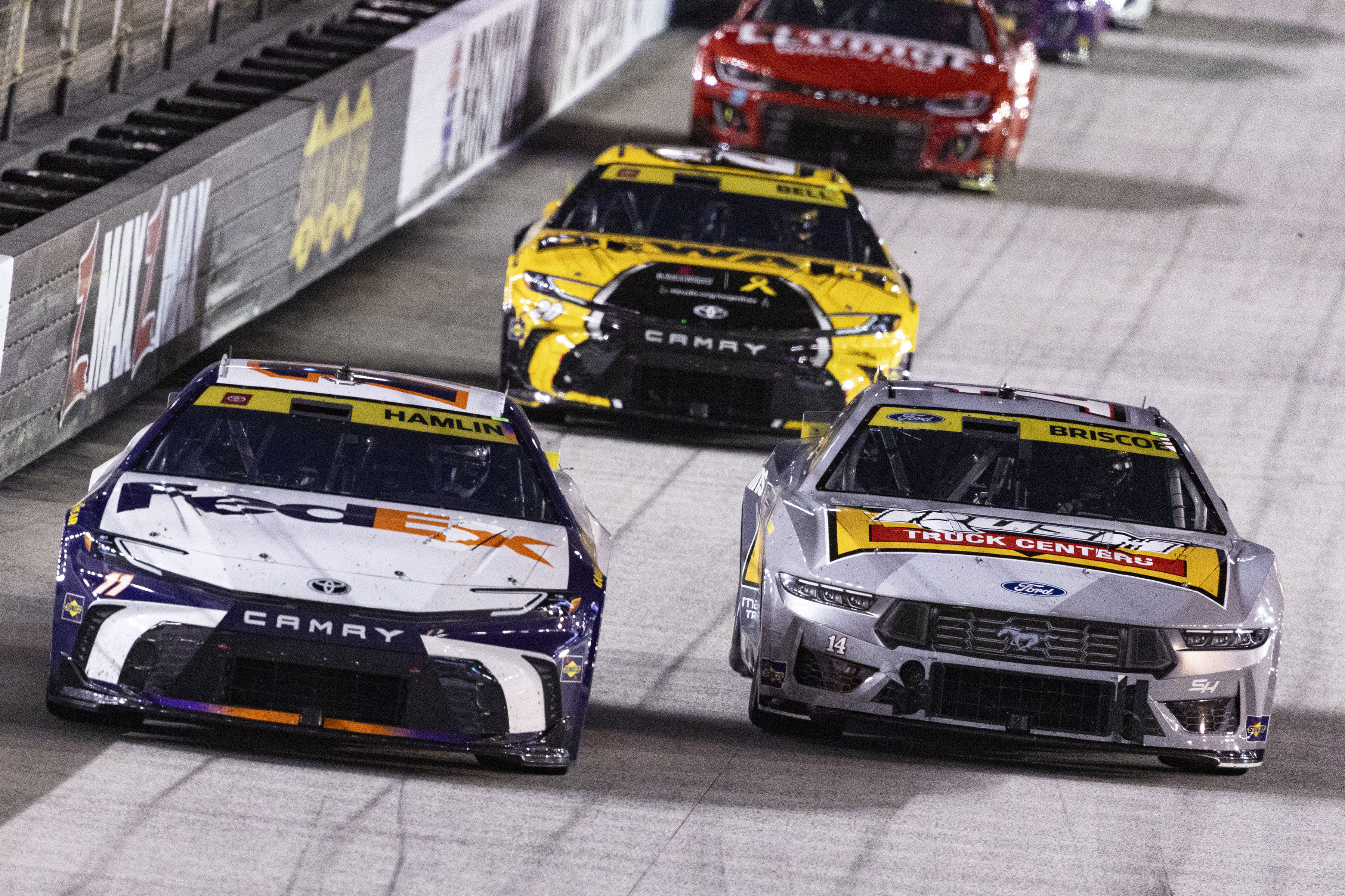 Denny Hamlin (11) leads Chase Briscoe (14) and Christopher Bell (20) during a NASCAR Cup Series auto race, Saturday, Sept. 21, 2024, in Bristol, Tenn. 