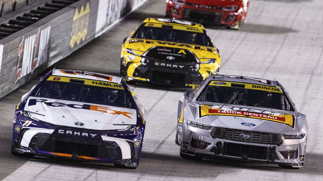 Denny Hamlin (11) leads Chase Briscoe (14) and Christopher Bell (20) during a NASCAR Cup Series auto race, Saturday, Sept. 21, 2024, in Bristol, Tenn.