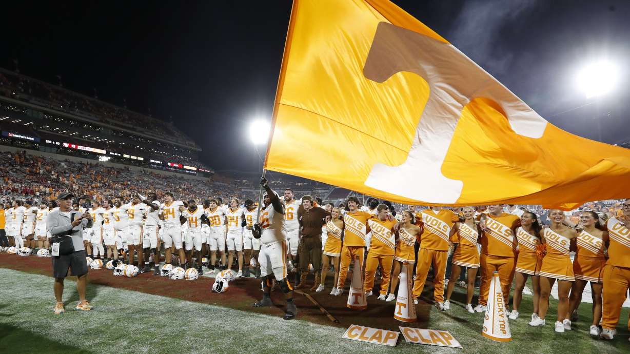 Tennessee offensive lineman Javontez Spraggins (76) waves a giant Tennessee flag after his team defeated Oklahoma in an NCAA college football game Saturday, Sept. 21, 2024, in Norman, Okla.
