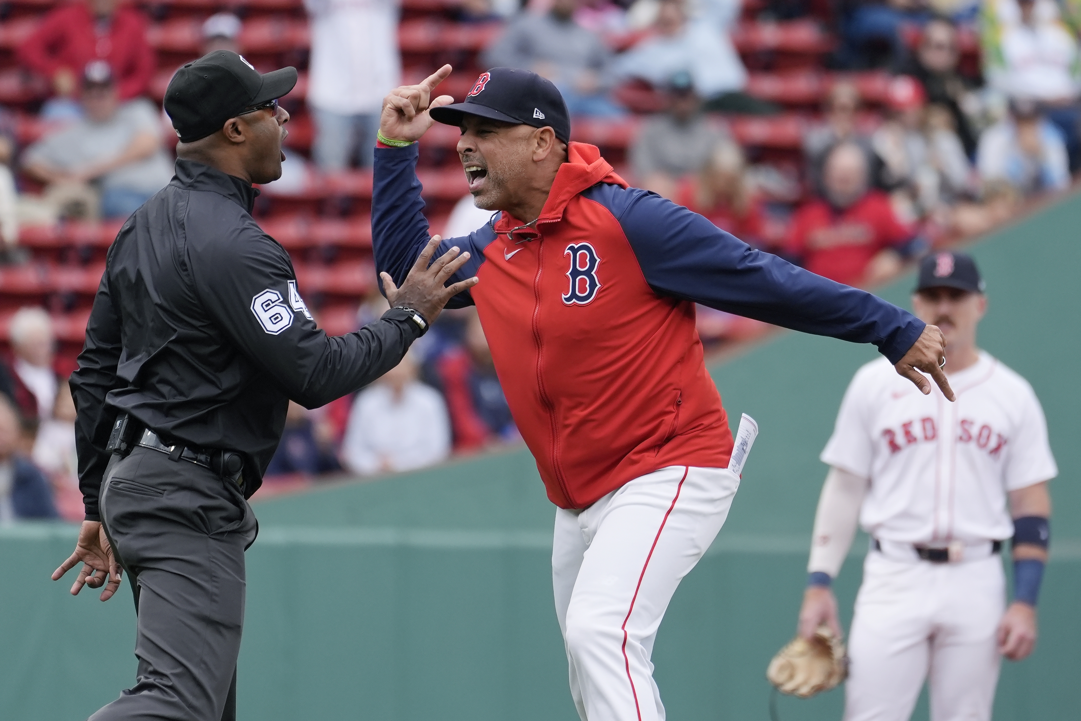 Boston Red Sox manager Alex Cora argues with umpire Alan Porter (64) after being ejected during the first inning of the first game of a baseball doubleheader against the Minnesota Twins, Sunday, Sept. 22, 2024, in Boston. 
