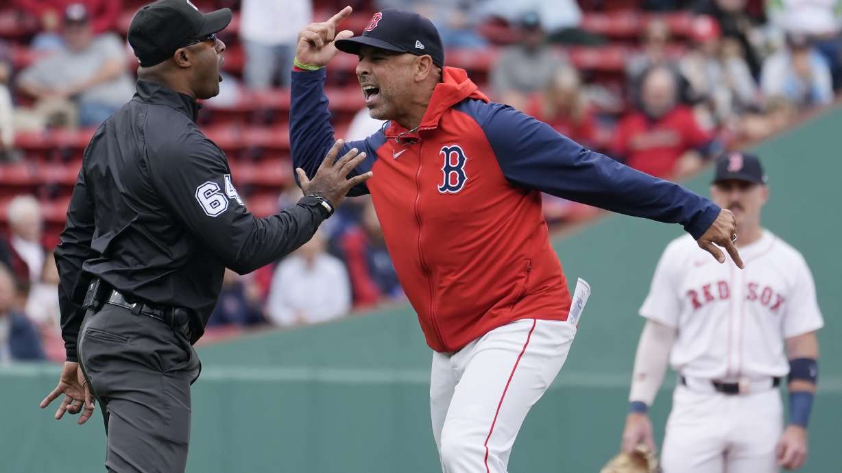 Boston Red Sox manager Alex Cora argues with umpire Alan Porter (64) after being ejected during the first inning of the first game of a baseball doubleheader against the Minnesota Twins, Sunday, Sept. 22, 2024, in Boston.