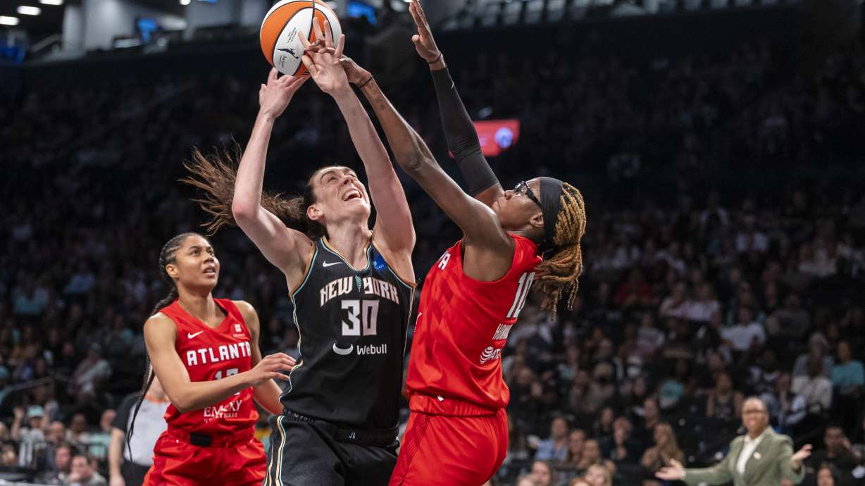 New York Liberty forward Breanna Stewart (30) is defended by Atlanta Dream guard Rhyne Howard (10) during the first half of a WNBA basketball first-round playoff game Sunday, Sept. 22, 2024, in New York.
