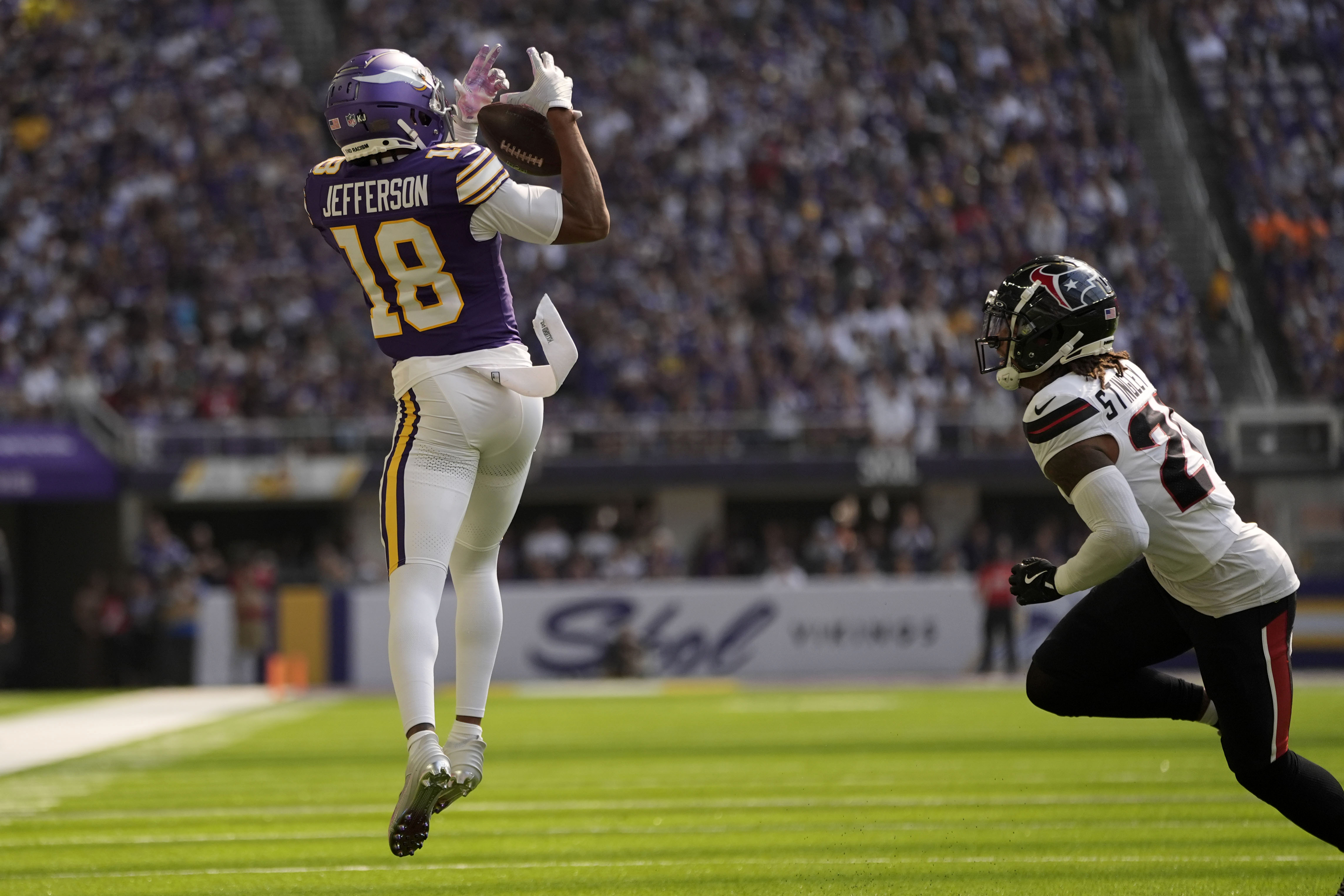 Minnesota Vikings wide receiver Justin Jefferson (18) catches a pass over Houston Texans cornerback Derek Stingley Jr. (24) during the first half of an NFL football game, Sunday, Sept. 22, 2024, in Minneapolis. 