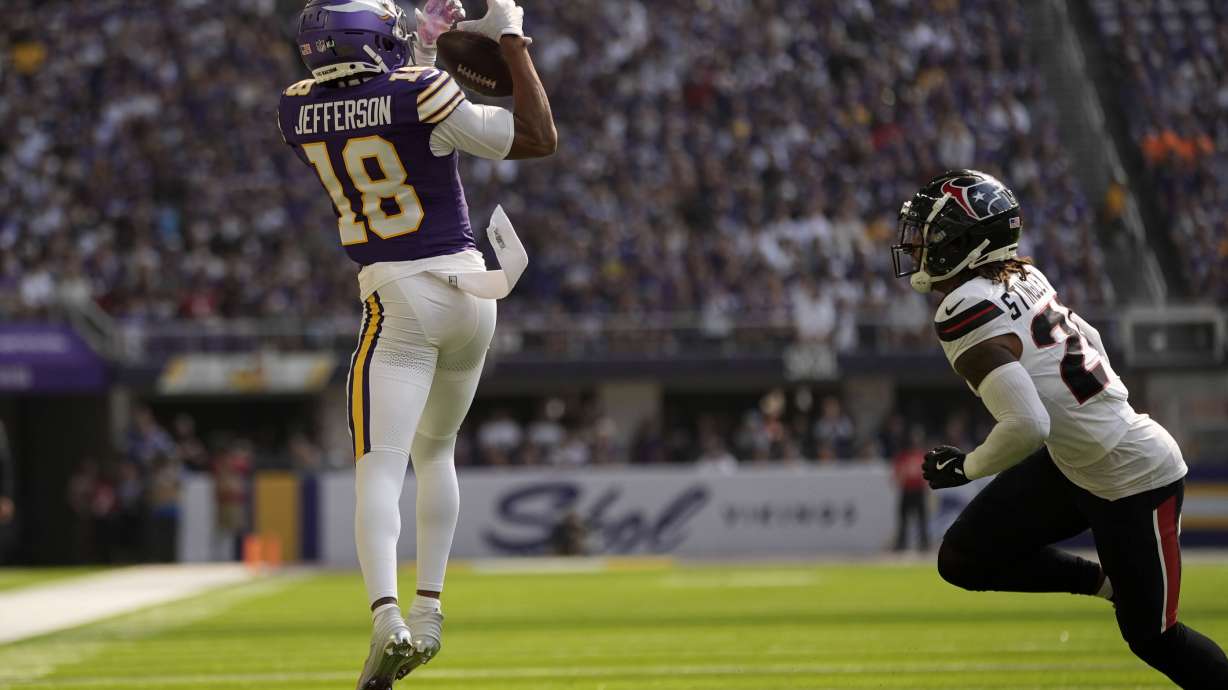 Minnesota Vikings wide receiver Justin Jefferson (18) catches a pass over Houston Texans cornerback Derek Stingley Jr. (24) during the first half of an NFL football game, Sunday, Sept. 22, 2024, in Minneapolis.