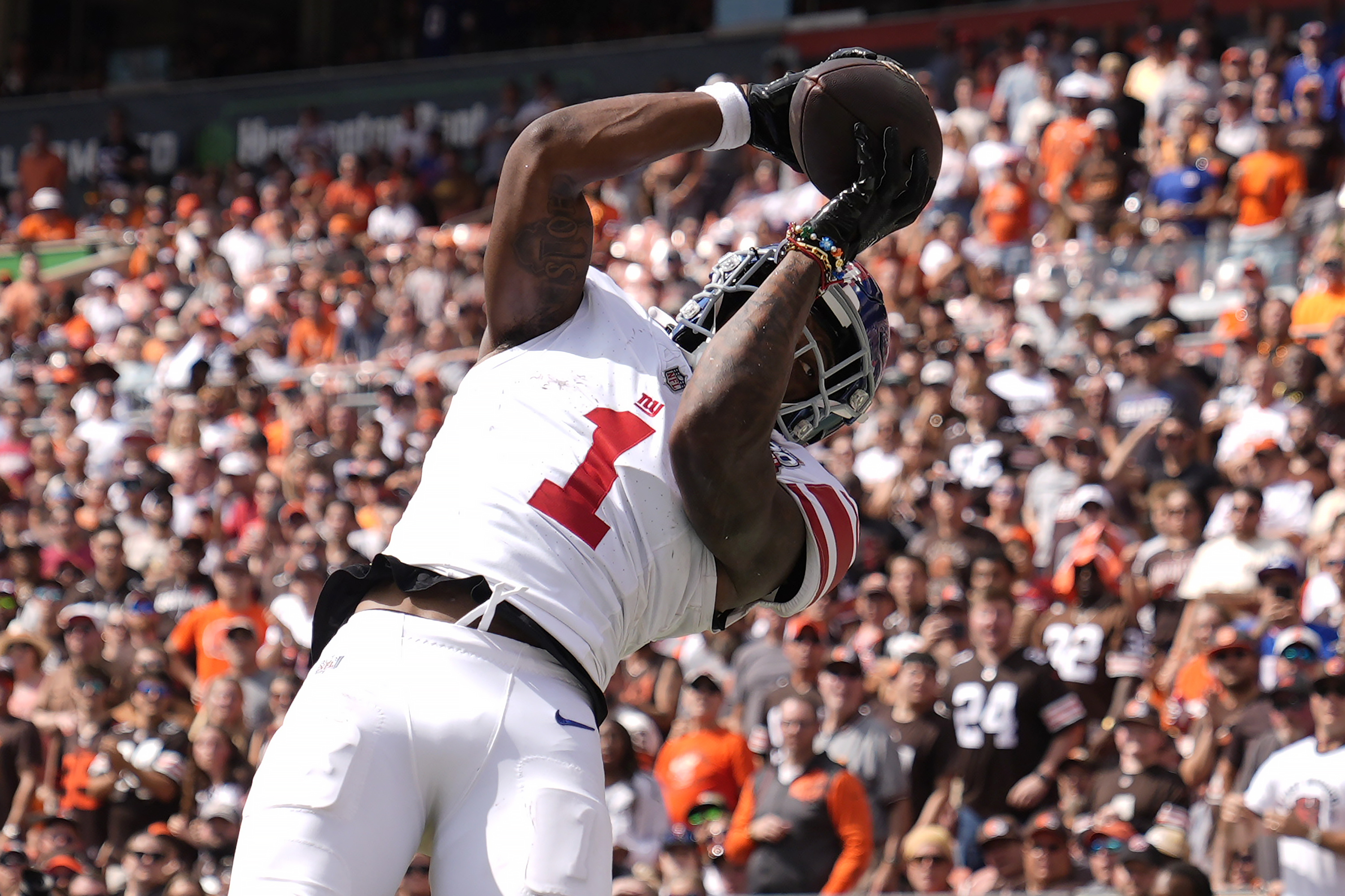 New York Giants wide receiver Malik Nabers (1) catches a touchdown pass against the Cleveland Browns during the first half of an NFL football game, Sunday, Sept. 22, 2024 in Cleveland.