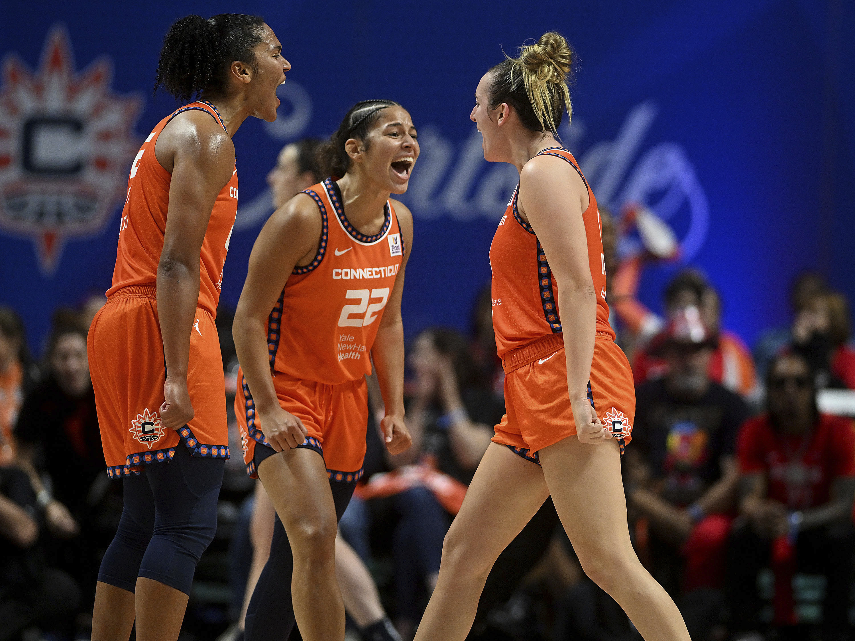Connecticut Sun's Alyssa Thomas (25), Veronica Burton (22) and Marina Mabrey (4) react after a basket during a first-round WNBA basketball playoff game against the Indiana Fever at Mohegan Sun Arena, Sunday, Sept. 22, 2024. 