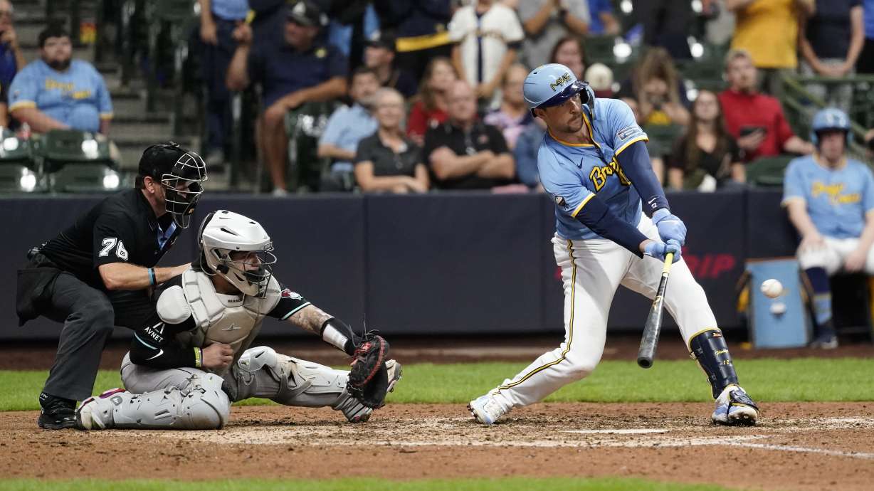 Milwaukee Brewers' Rhys Hoskins hits a two-run single during the eighth inning of a baseball game against the Arizona Diamondbacks, Sunday, Sept. 22, 2024, in Milwaukee.