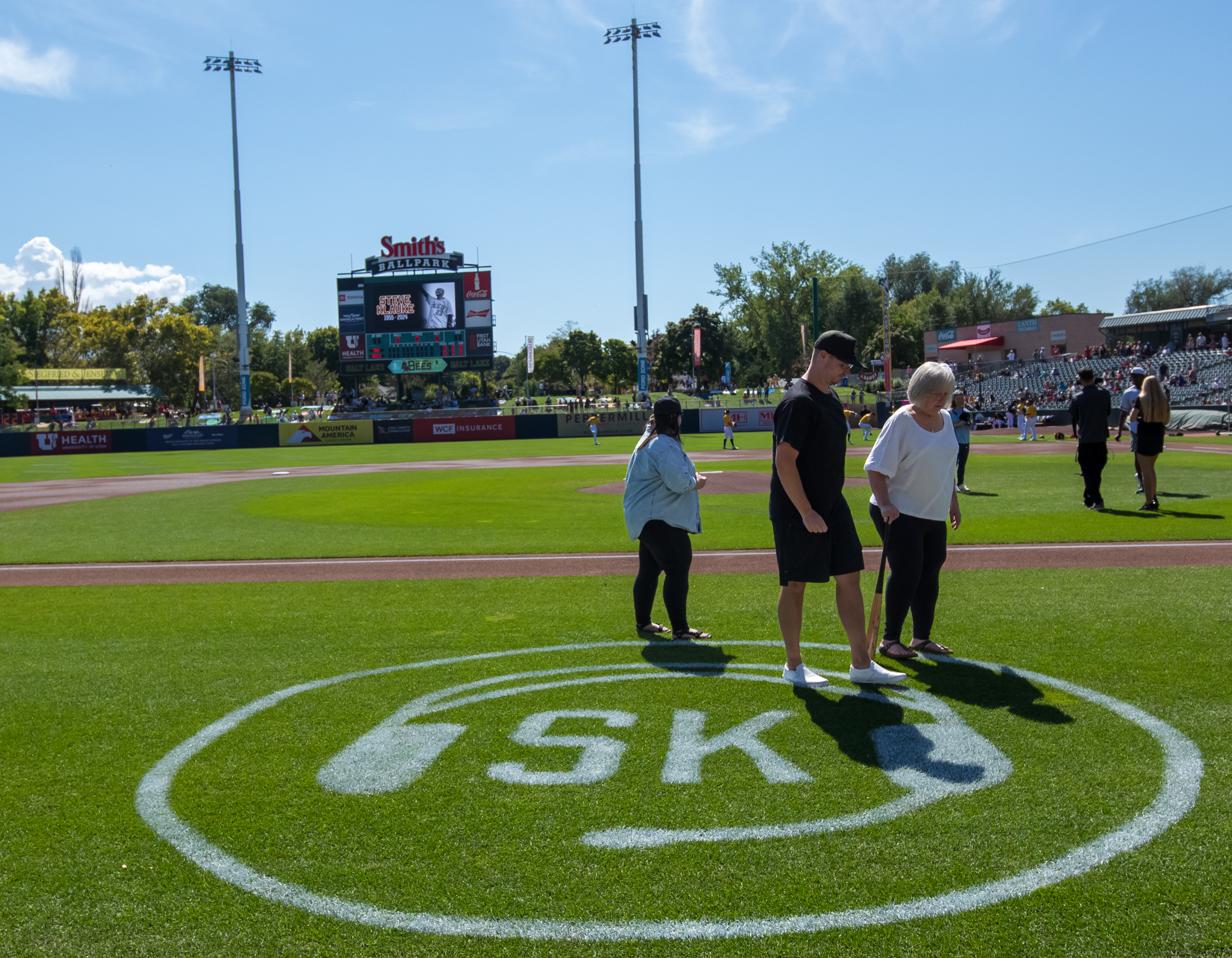 The family of longtime Salt Lake Bees broadcaster Steve Klauke walk off the field after a special moment honoring Klauke at the final Bees game at Smith's Ballpark on Sunday.