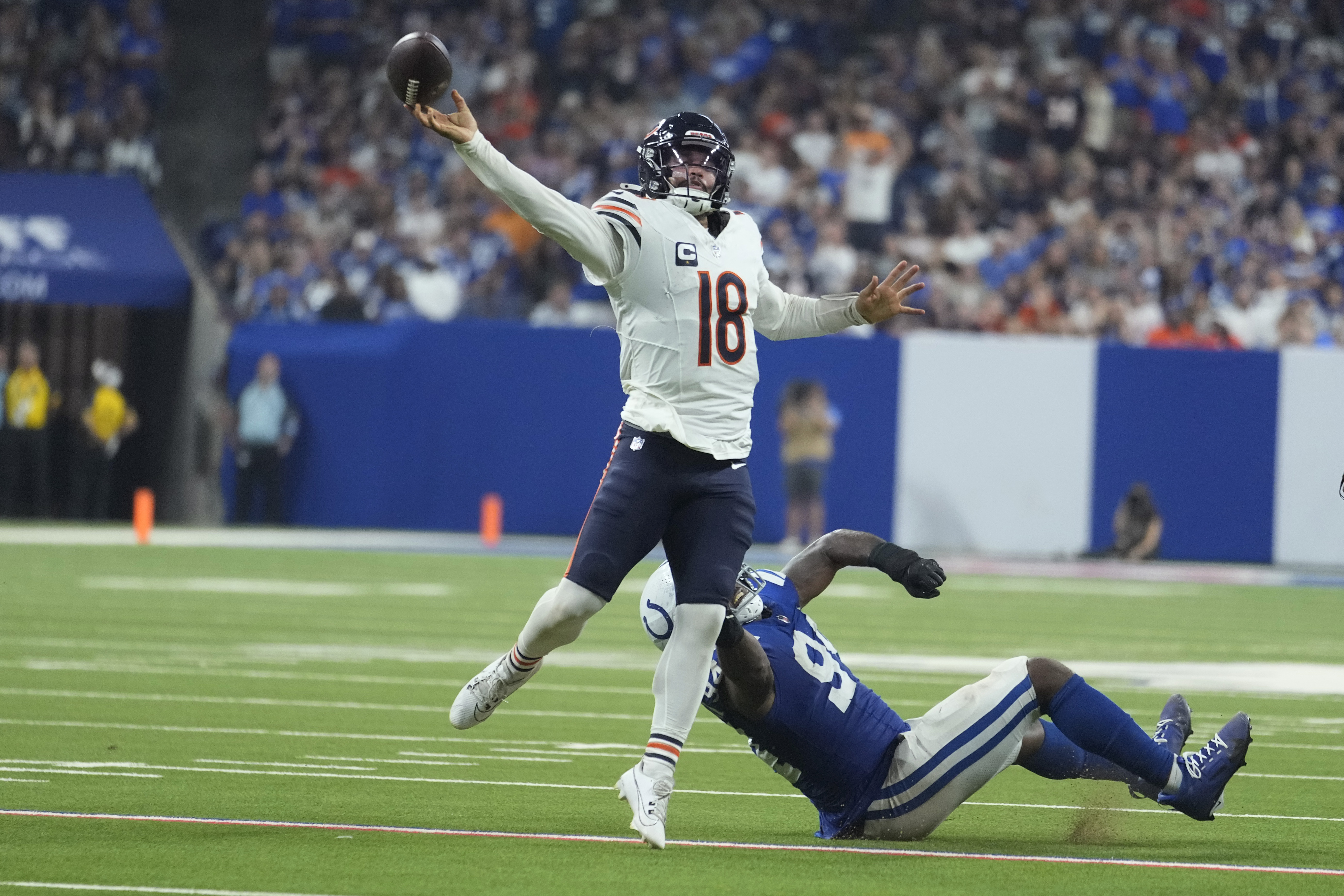 Chicago Bears quarterback Caleb Williams (18) is pressured by Indianapolis Colts defensive end Tyquan Lewis (94) during the second half of an NFL football game Sunday, Sept. 22, 2024, in Indianapolis.