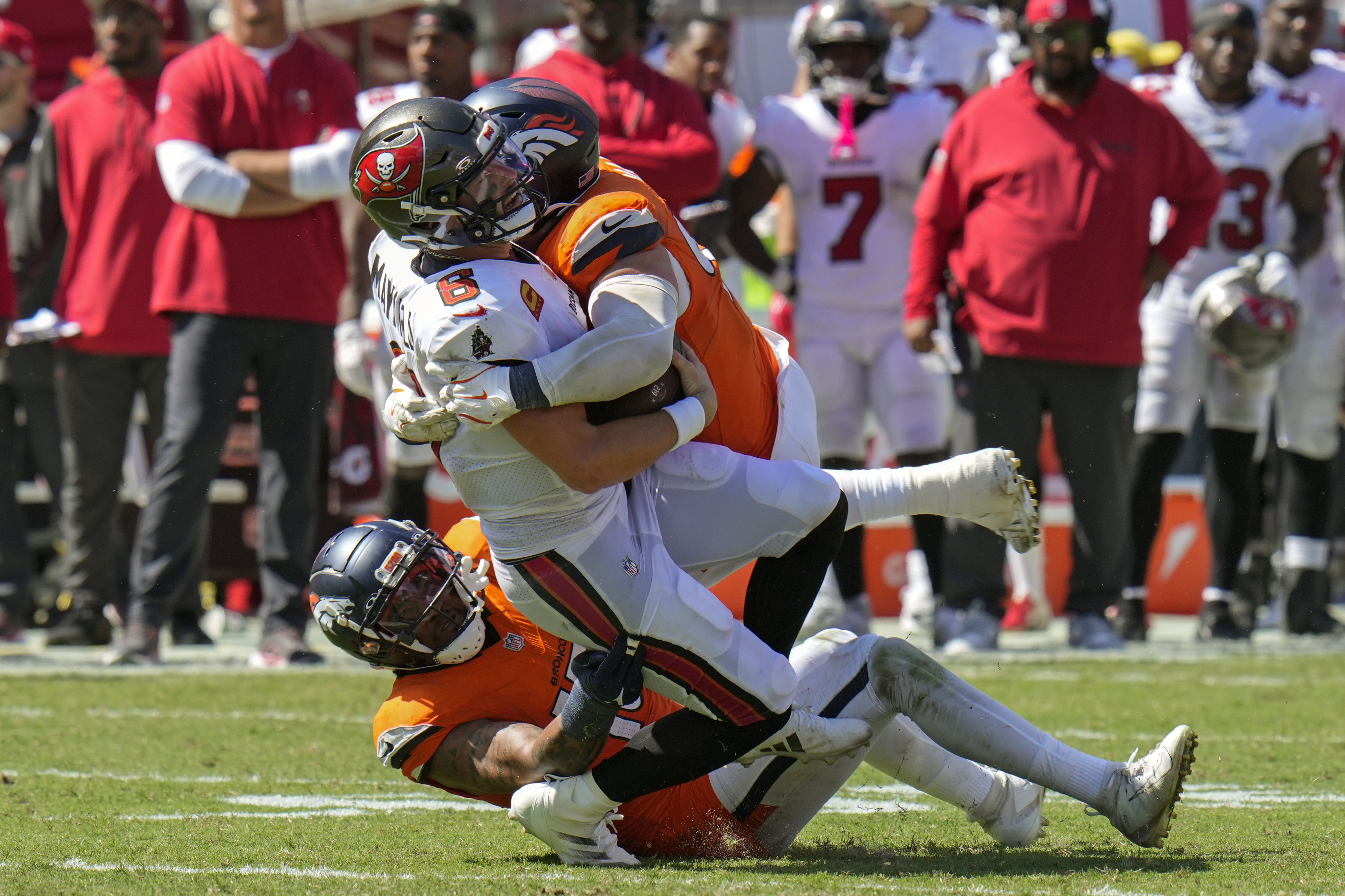 Tampa Bay Buccaneers quarterback Baker Mayfield, center, is tackled by Denver Broncos defensive end Zach Allen on a fourth down play during the second half of an NFL football game, in Tampa, Fla. on Sunday, Sept. 22, 2024.