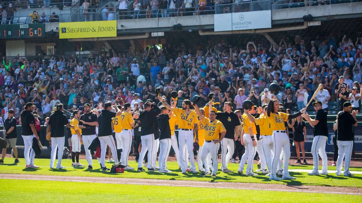 Salt Lake Bees players and coaches tip their caps and wave to fans after the last out is recorded in the team's 3-1 loss to Oklahoma City on Sunday. It was the last Bees game at Smith's Ballpark.