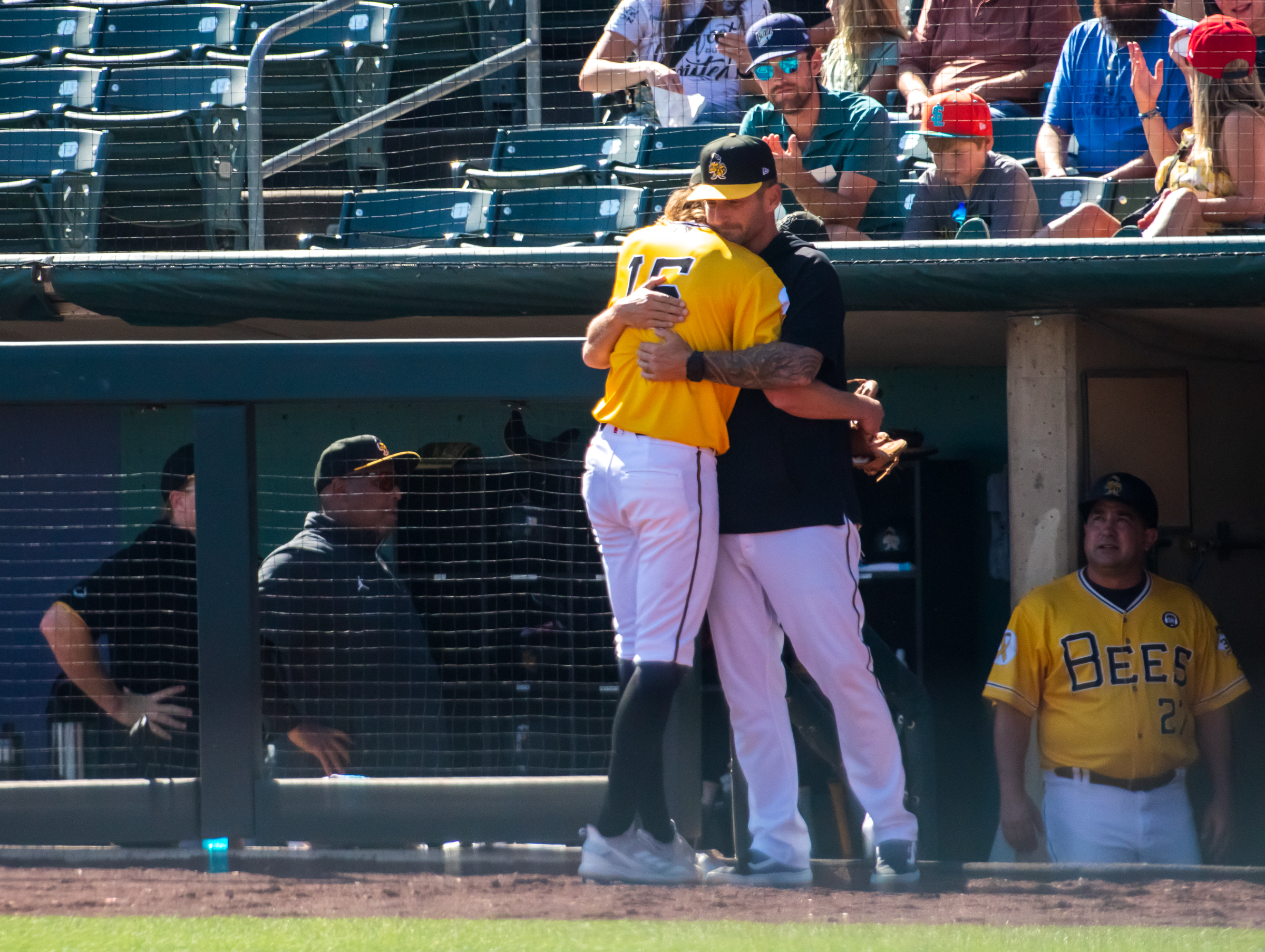 Salt Lake Bees pitching coach Shane Loux hugs pitcher Adam Cimber after he is pulled from the Bees' game in the eighth inning of the team's 3-1 loss. Cimber said he plans to retire and his outing Sunday was the last of his career.