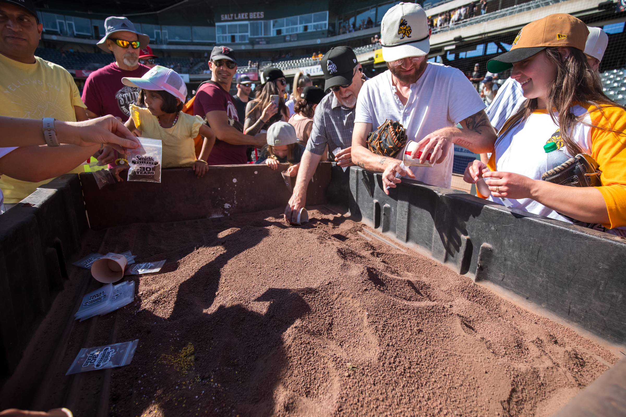 Fans scoop up Smith's Ballpark dirt after the the team's final game at the ballpark on Sunday.