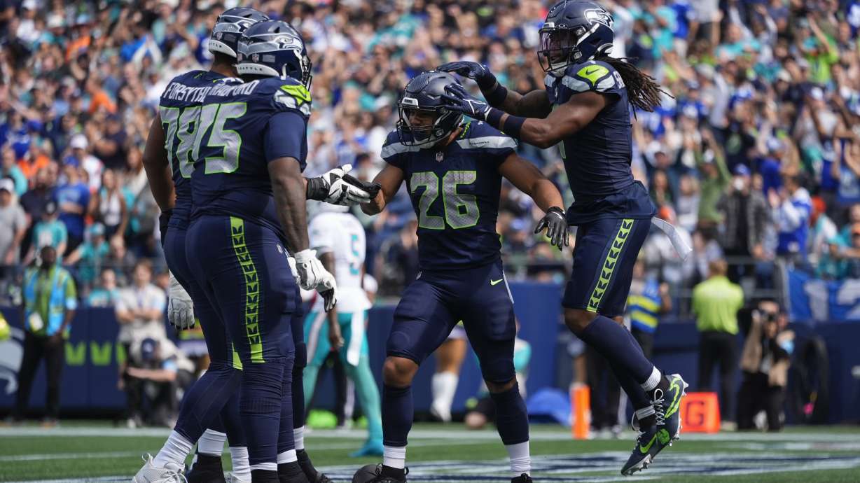 Seattle Seahawks running back Zach Charbonnet (26) reacts after scoring a touchdown during the first half of an NFL football game against the Miami Dolphins, Sunday, Sept. 22, 2024, in Seattle.