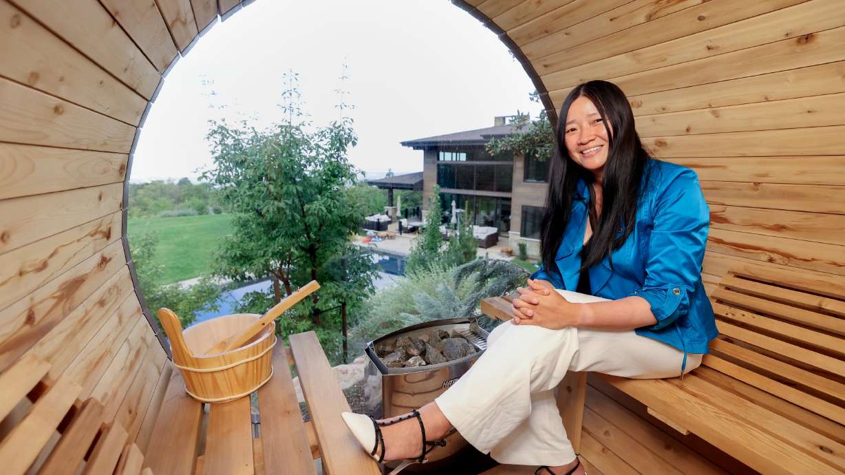 Amy Sunderland poses for a portrait in a sauna overlooking her home in Millcreek on Sept. 12. Sunderland grew up very poor in China.
