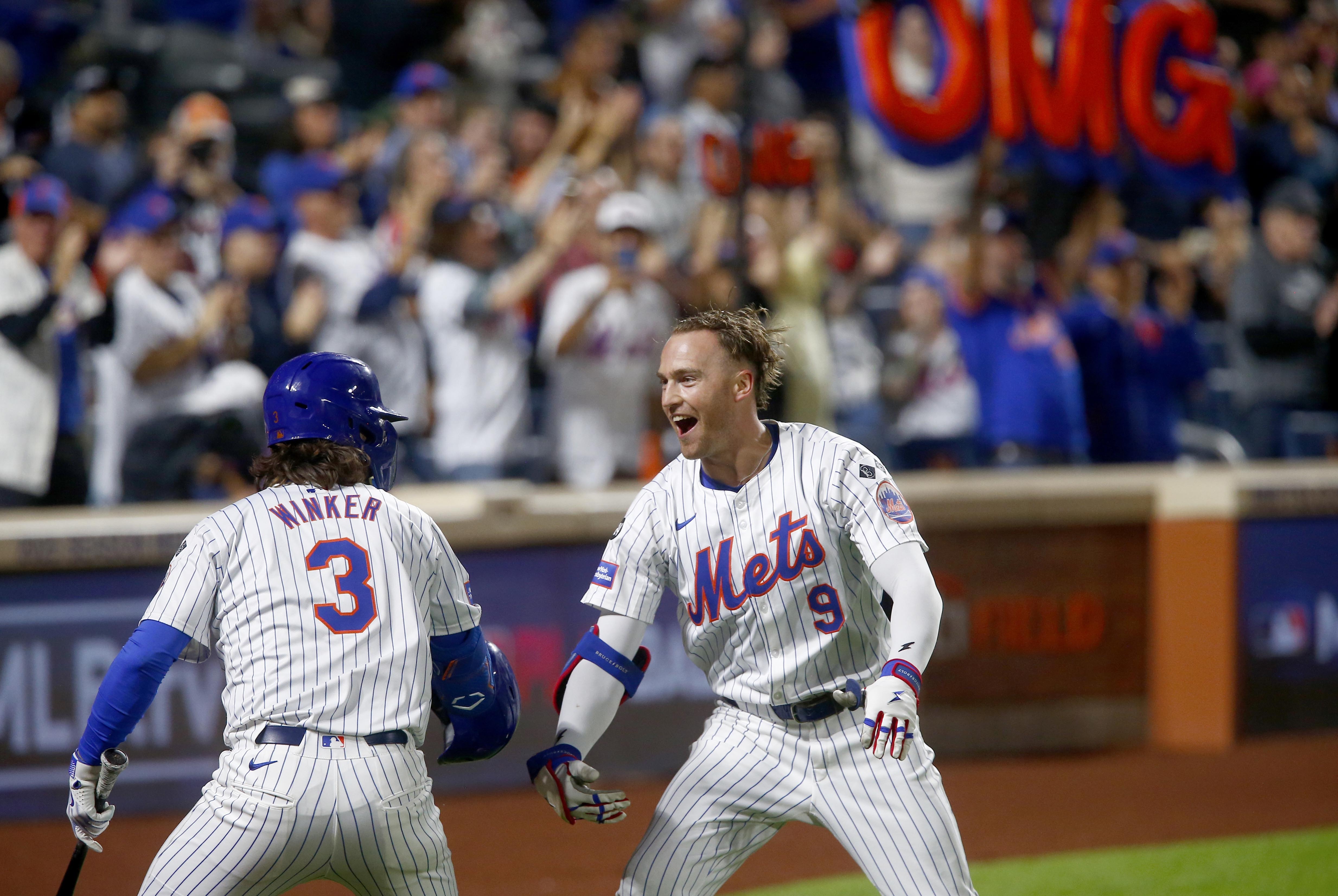 New York Mets' Jesse Winker, left, and Brandon Nimmo celebrate Nimmo's home run in the sixth inning during a baseball game Sunday, Sept. 22, 2024, in New York. 