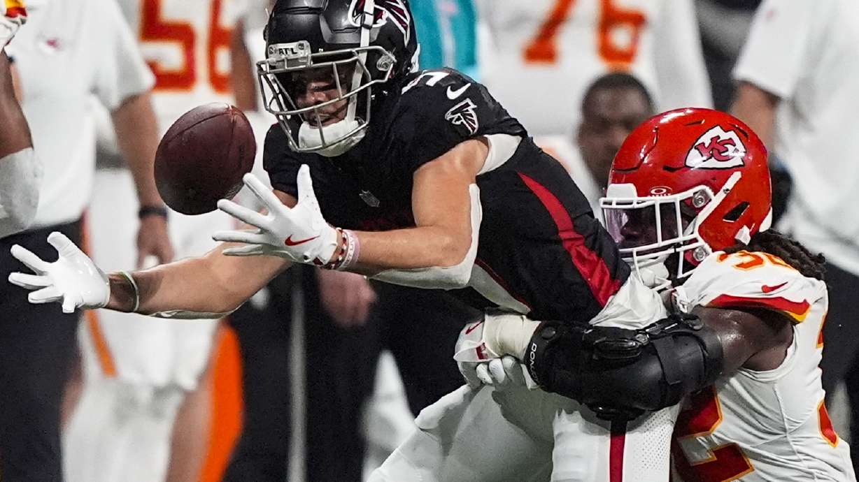 Atlanta Falcons wide receiver Drake London (5) loses the ball but recovers against Kansas City Chiefs linebacker Nick Bolton (32) during the second half of an NFL football game, Sunday, Sept. 22, 2024, in Atlanta.