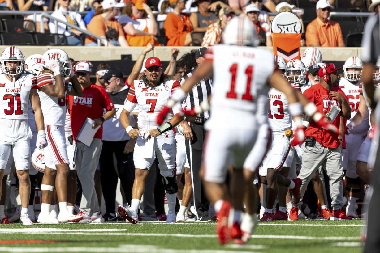 Utah quarterback Cameron Rising (7) celebrates on the sidelines in the first half of an NCAA college football game against Oklahoma State Saturday, Sept. 21, 2024, in Stillwater, Okla.