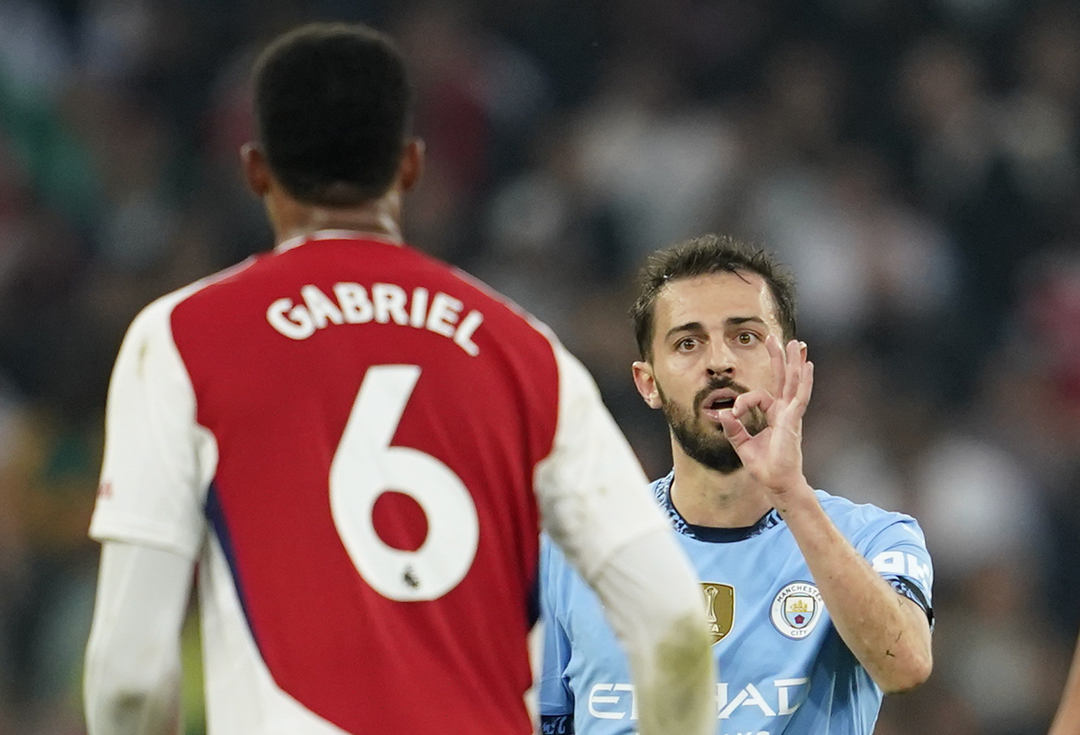 Manchester City's Bernardo Silva gestures at Arsenal's Gabriel during the English Premier League soccer match between Manchester City and Arsenal at the Etihad stadium in Manchester, England, Sunday, Sept. 22, 2024. 