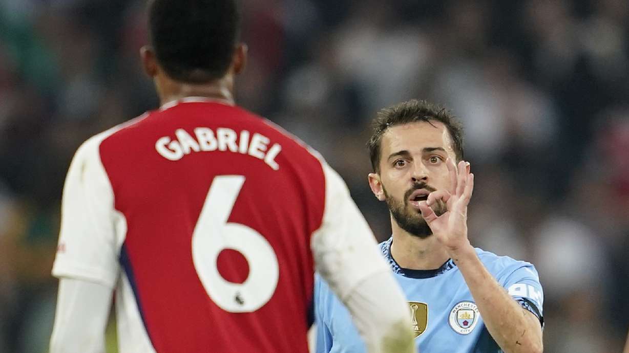 Manchester City's Bernardo Silva gestures at Arsenal's Gabriel during the English Premier League soccer match between Manchester City and Arsenal at the Etihad stadium in Manchester, England, Sunday, Sept. 22, 2024.