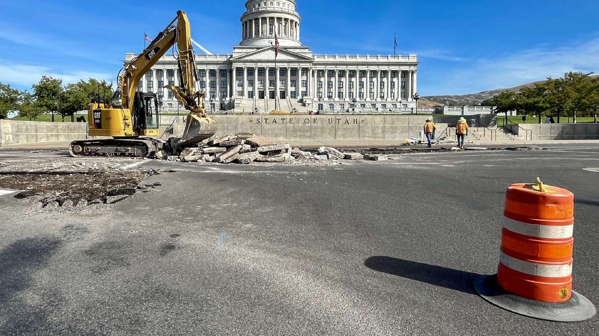 Construction crews dig into the intersection of 300 North and State Street in Salt Lake City Monday. Utah Department of Transportation officials say the current design will be replaced with a new roundabout.