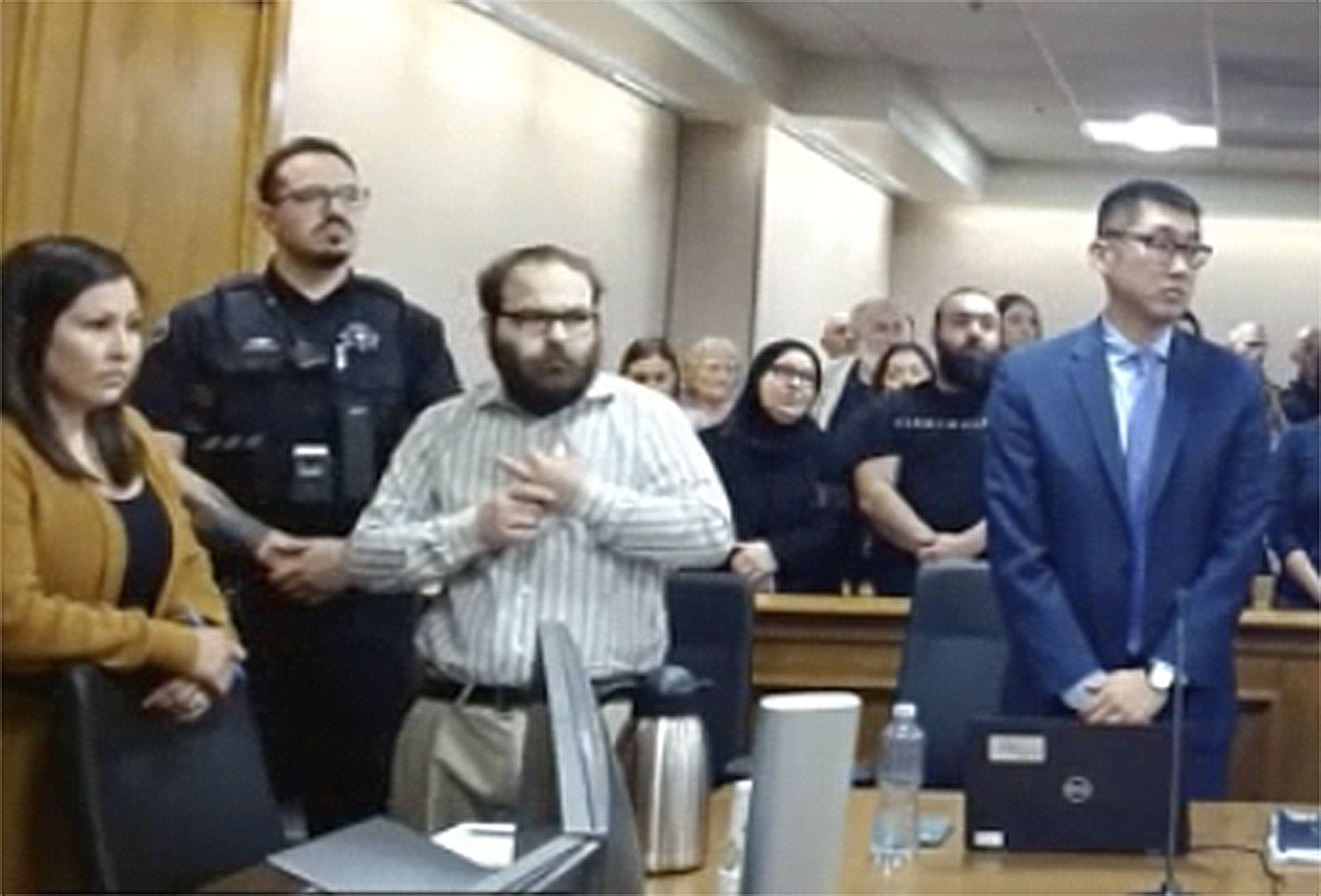 In this image taken from video provided by the Colorado Judicial Branch, Ahmad Alissa, third from left, stands for the verdict in his trial for the 2021 Colorado supermarket shootings, Monday in Boulder, Colo.