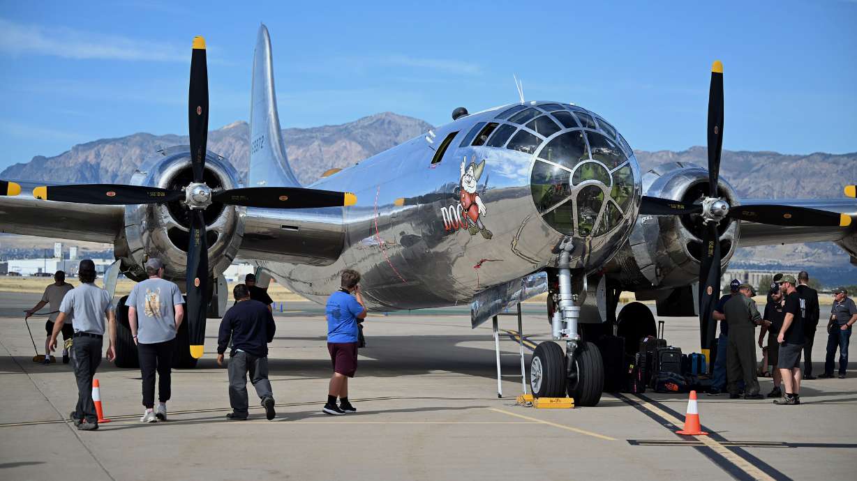 Plane enthusiasts admire Doc, one of only two flying B-29 Superfortress planes still flying worldwide, sitting at Ogden-Hinckley Regional Airport on Monday.