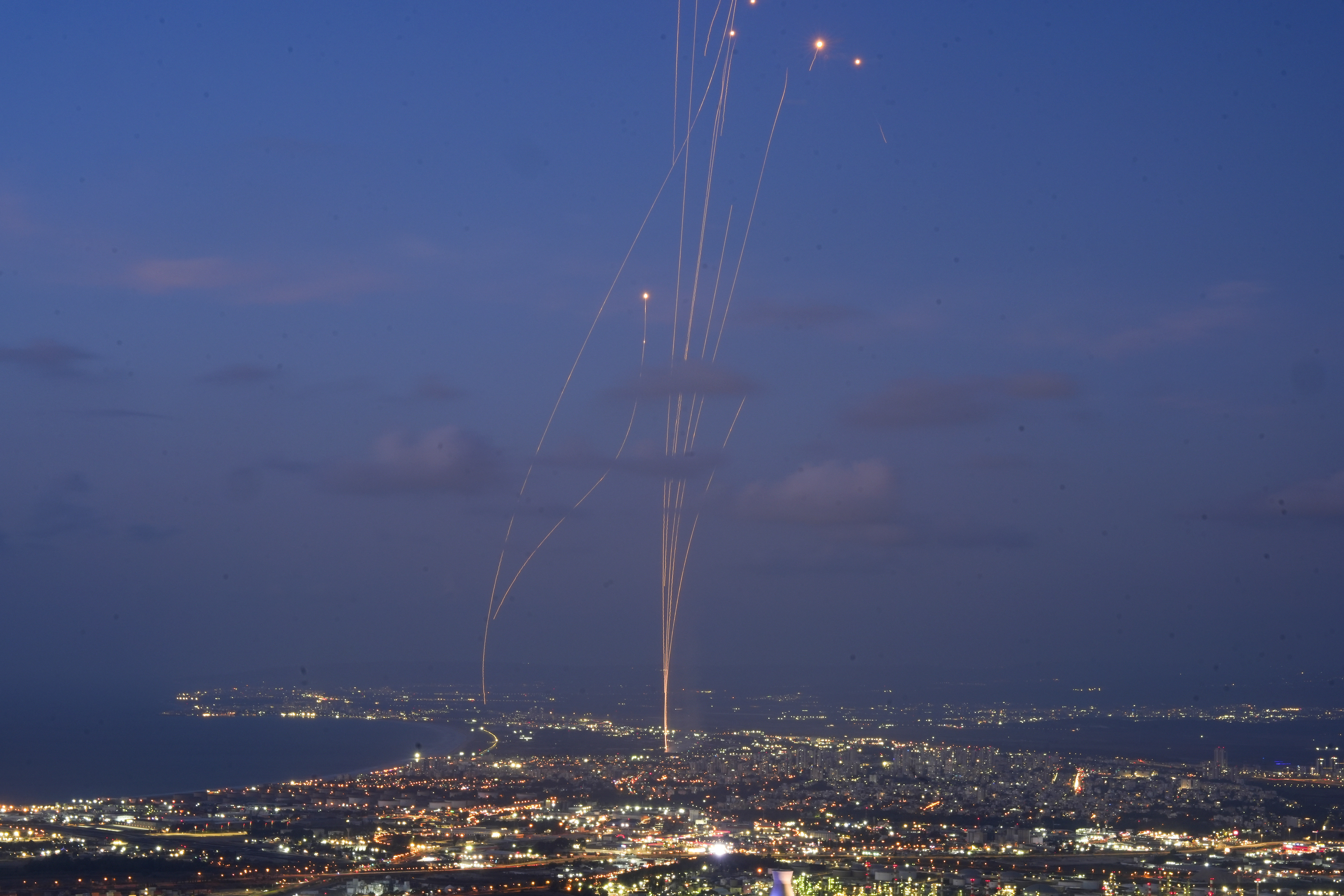 Israeli Iron Dome air defense system fires to intercept rockets that were launched from Lebanon, as seen from Haifa, northern Israel, Monday.