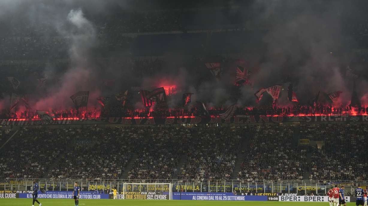 AC Milan's fans lit flares after Christian Pulisic scored the opening goal during the Serie A soccer match between Inter Milan and AC Milan at the San Siro stadium in Milan, Italy, Sunday, Sept.22, 2024.