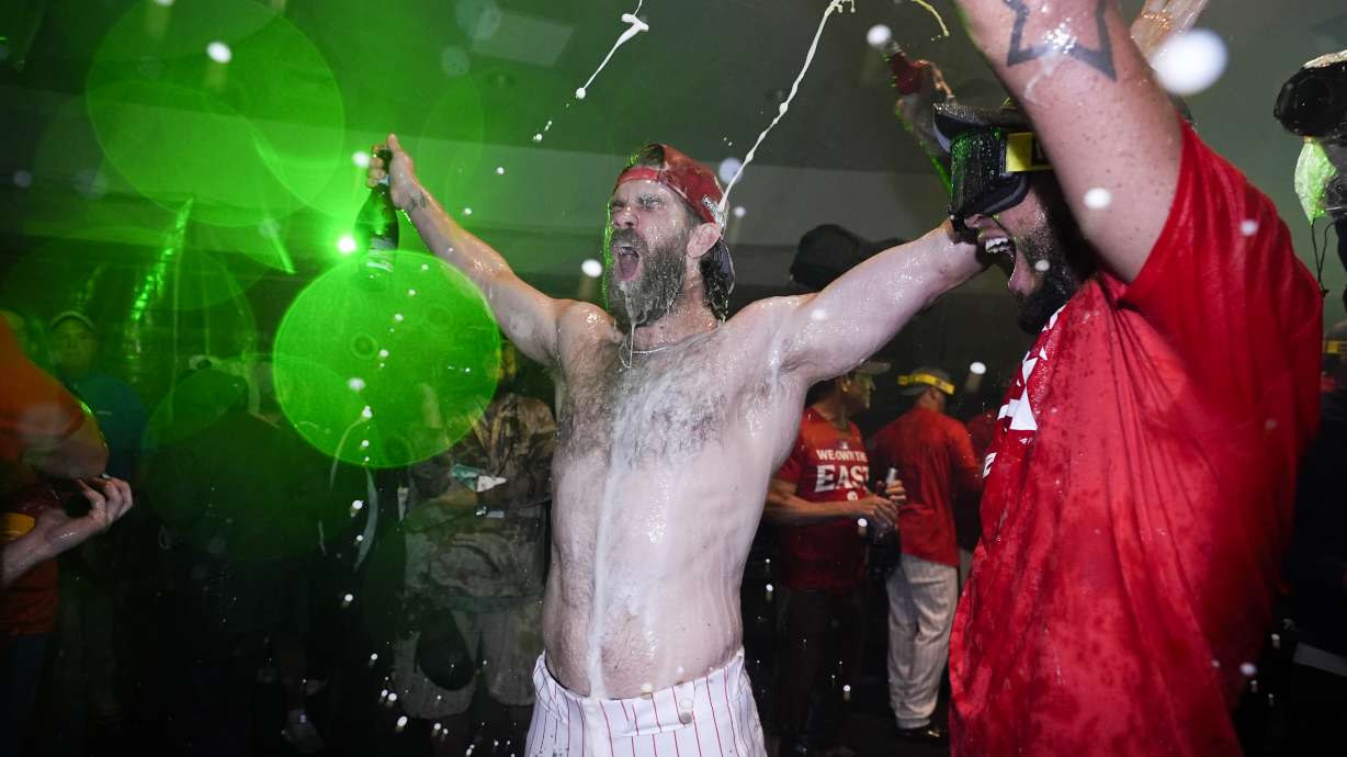 Philadelphia Phillies' Bryce Harper celebrates after the Phillies won a baseball game against the Chicago Cubs to clinch the NL East title, Monday, Sept. 23, 2024, in Philadelphia.