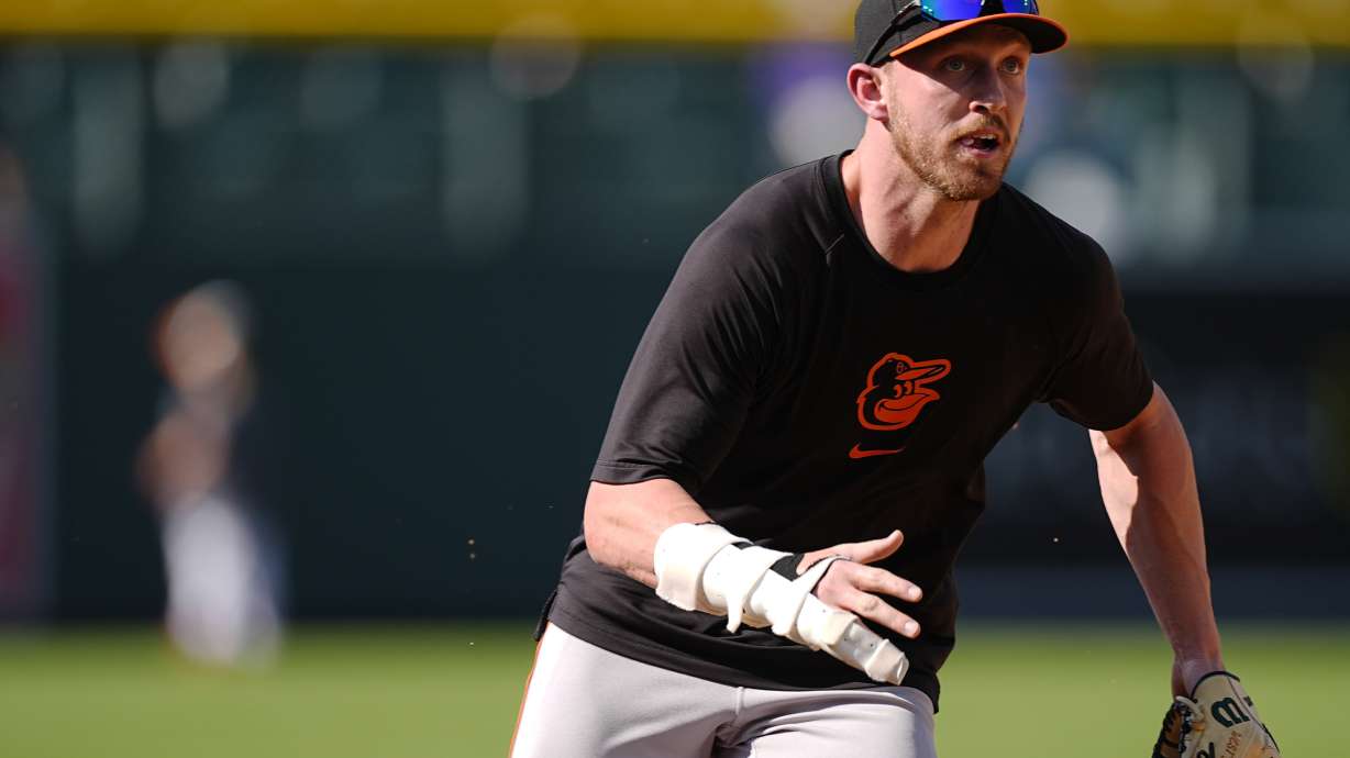 Injured Baltimore Orioles first baseman Ryan Mountcastle warms up before a baseball game against the Colorado Rockies, Saturday, Aug. 31, 2024, in Denver.
