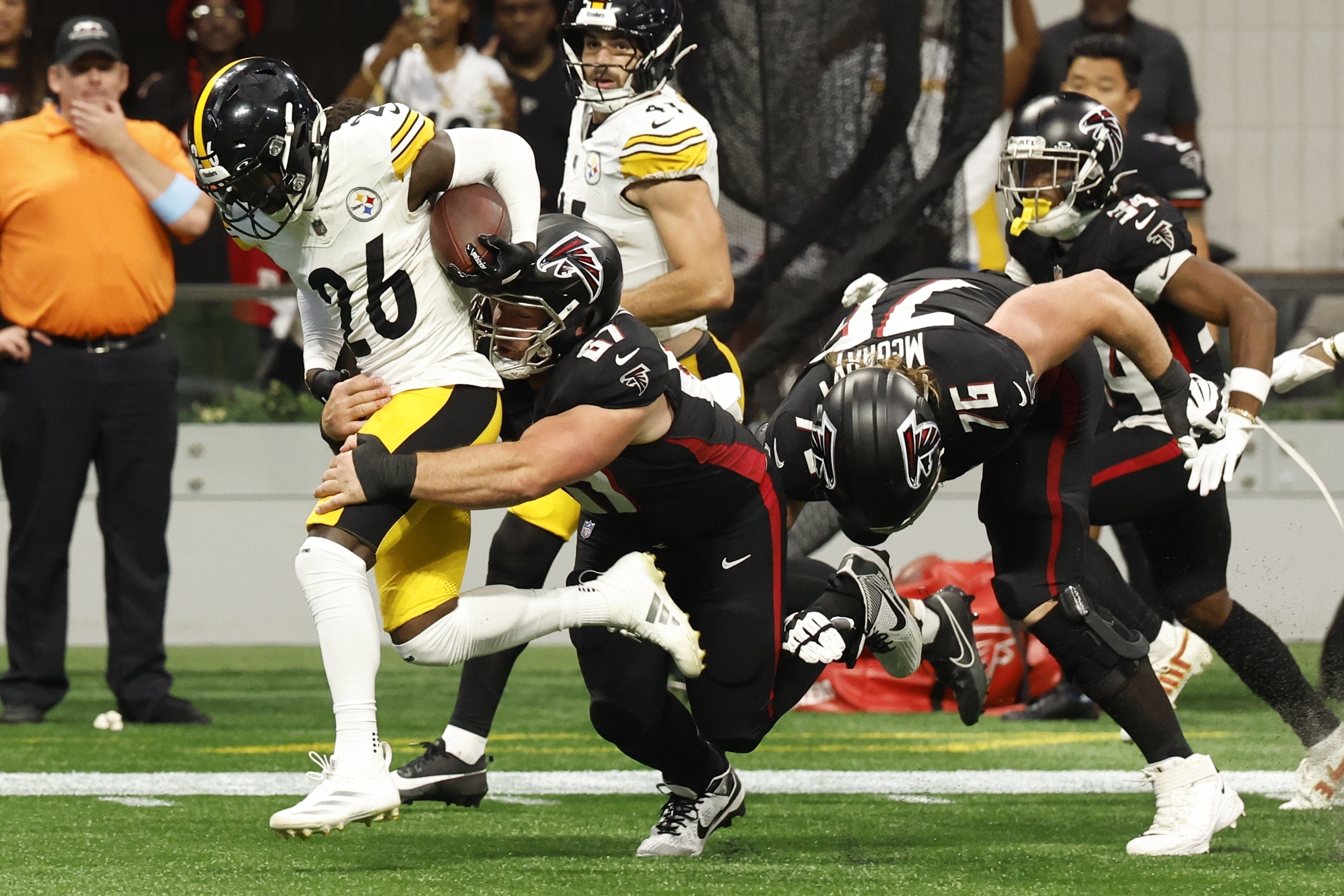 Pittsburgh Steelers cornerback Donte Jackson (26) is tackled by Atlanta Falcons center Drew Dalman (67) after an interception during the second half of an NFL football game Sunday, Sept. 8, 2024, in Atlanta.