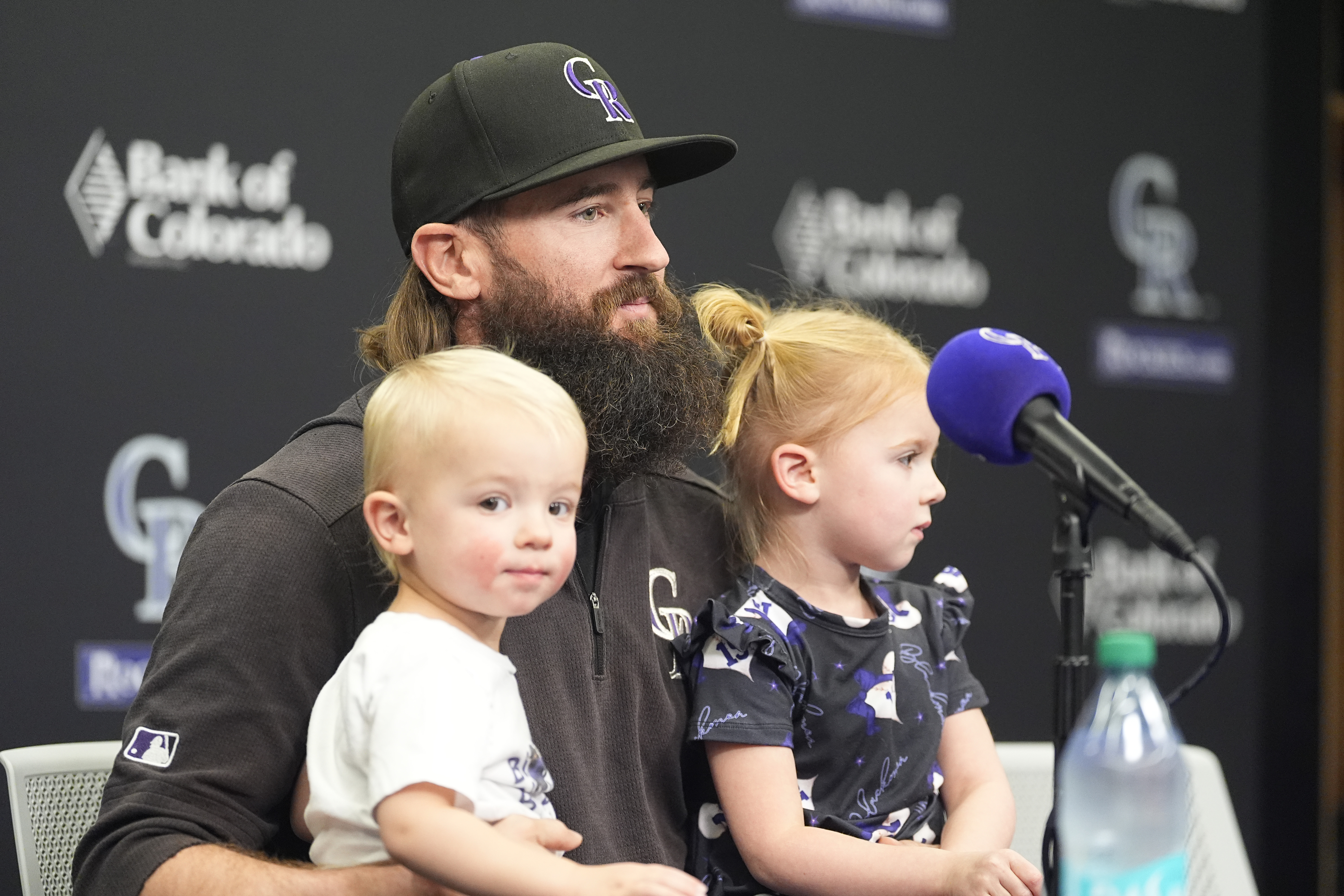 Colorado Rockies right fielder Charlie Blackmon talks to reporters during a news conference to discuss his retirement from the sport at season's end as his 2-year-old son, Wyatt, left, and 3-year-old daughter, Josie, look on Tuesday, Sept. 24, 2024, in Denver. 