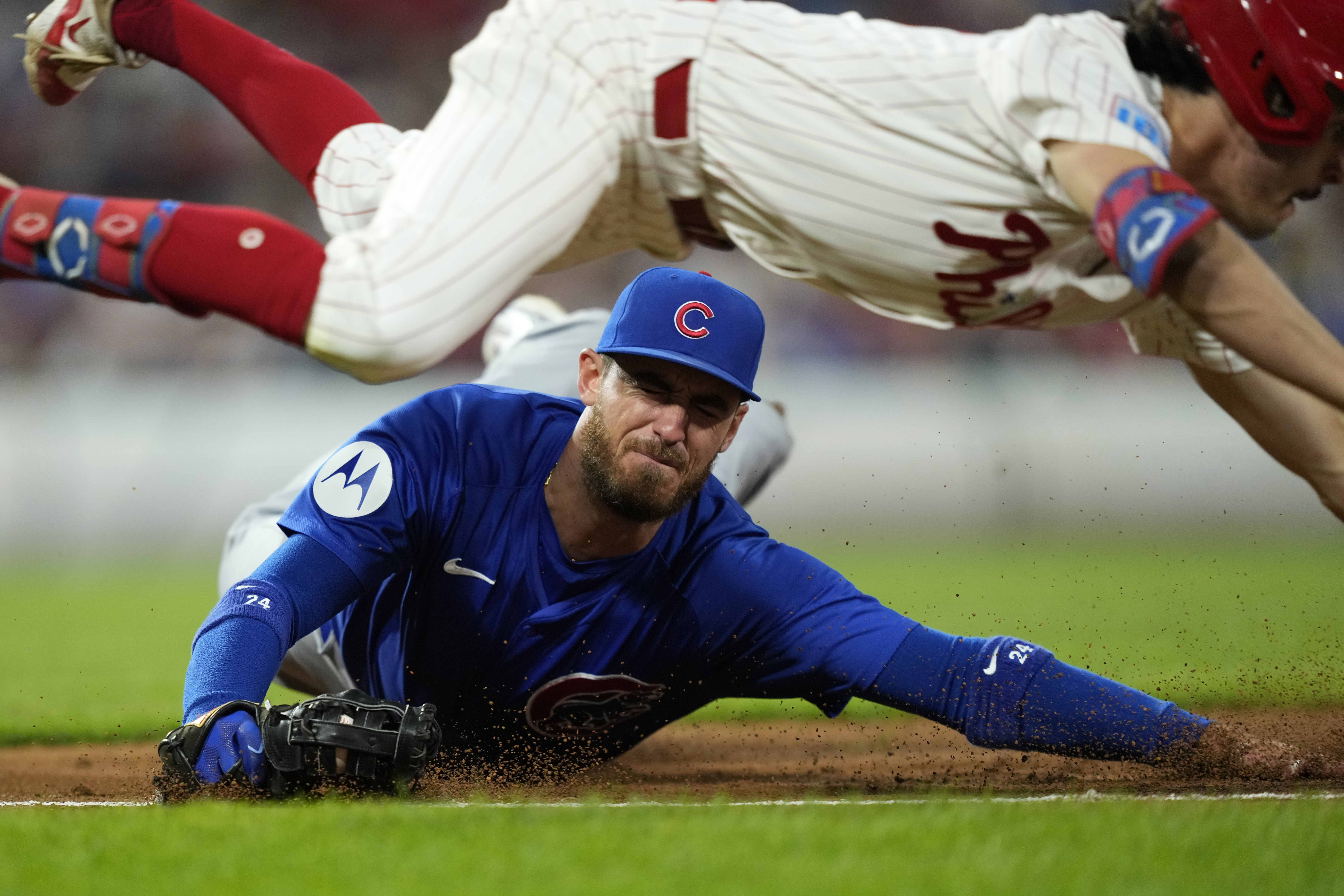 Chicago Cubs first baseman Cody Bellinger, bottom, cannot tag Philadelphia Phillies' Garrett Stubbs after Stubbs' run-scoring bunt single during the second inning of a baseball game, Tuesday, Sept. 24, 2024, in Philadelphia. 