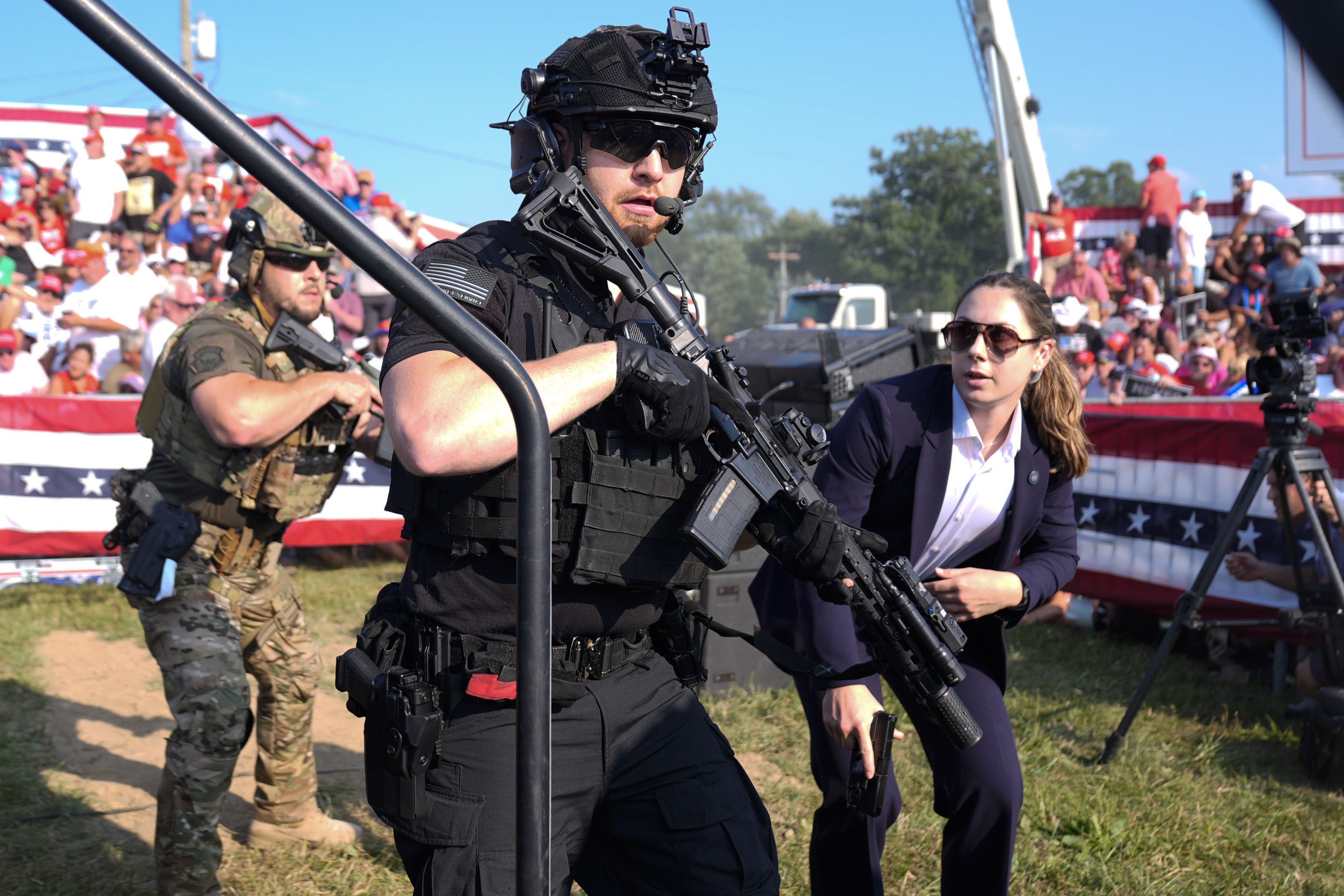 U.S. Secret Service agents respond as Republican presidential candidate former President Donald Trump is surrounded on stage by U.S. Secret Service agents at a campaign rally, July 13 in Butler, Pa. A bipartisan Senate investigation found the shooting was "preventable."