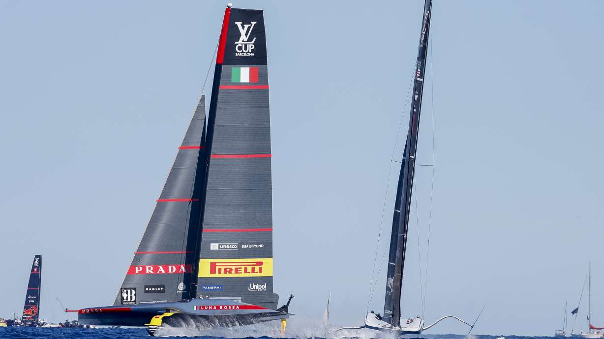Luna Rosa Prada Pirelli Team's AC75, left, and American Magic's AC75 boat sail during Semi-final America's Cup Regatta ahead of the 37th America's Cup sailing race along Barcelona's coast, Spain, Saturday, Sep. 14, 2024.