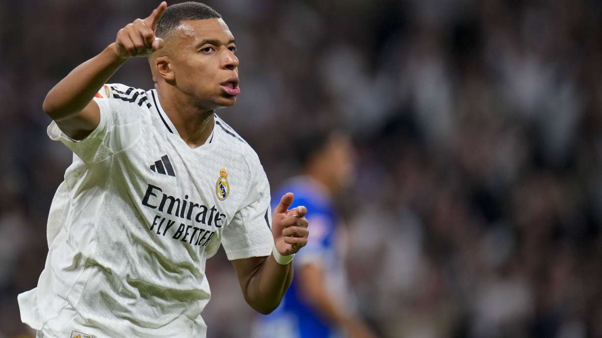 Real Madrid's Kylian Mbappe celebrates after scoring his side's second goal during a Spanish La Liga soccer match between Real Madrid and Alaves at Santiago Bernabeu stadium in Madrid, Spain, Tuesday, Sept. 24, 2024.