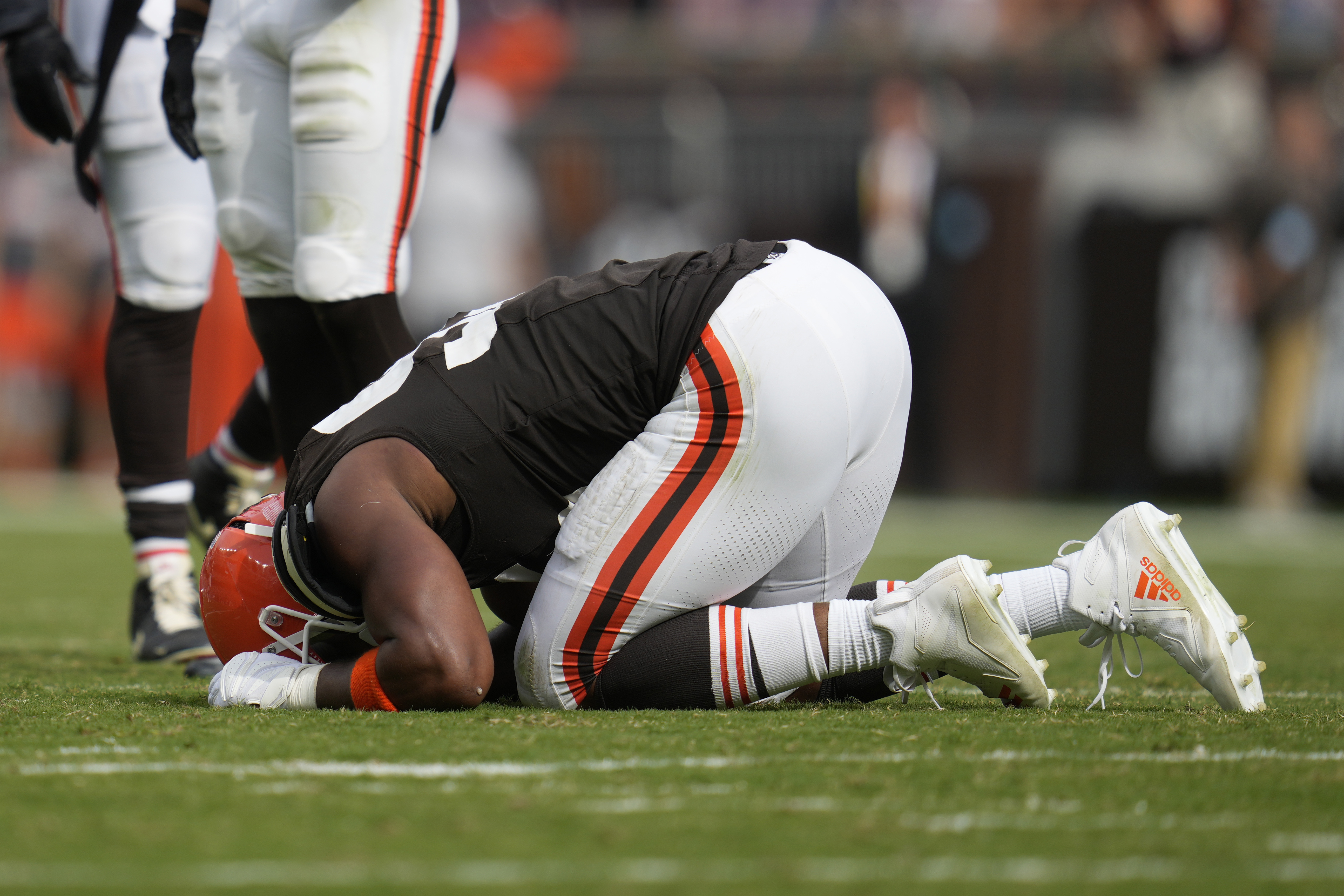 Cleveland Browns' Myles Garrett kneels on the field after an injury in the second half of an NFL football game against the New York Giants, Sunday, Sept. 22, 2024, in Cleveland. 