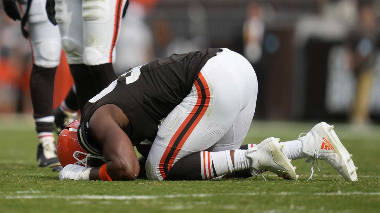 Cleveland Browns' Myles Garrett kneels on the field after an injury in the second half of an NFL football game against the New York Giants, Sunday, Sept. 22, 2024, in Cleveland.