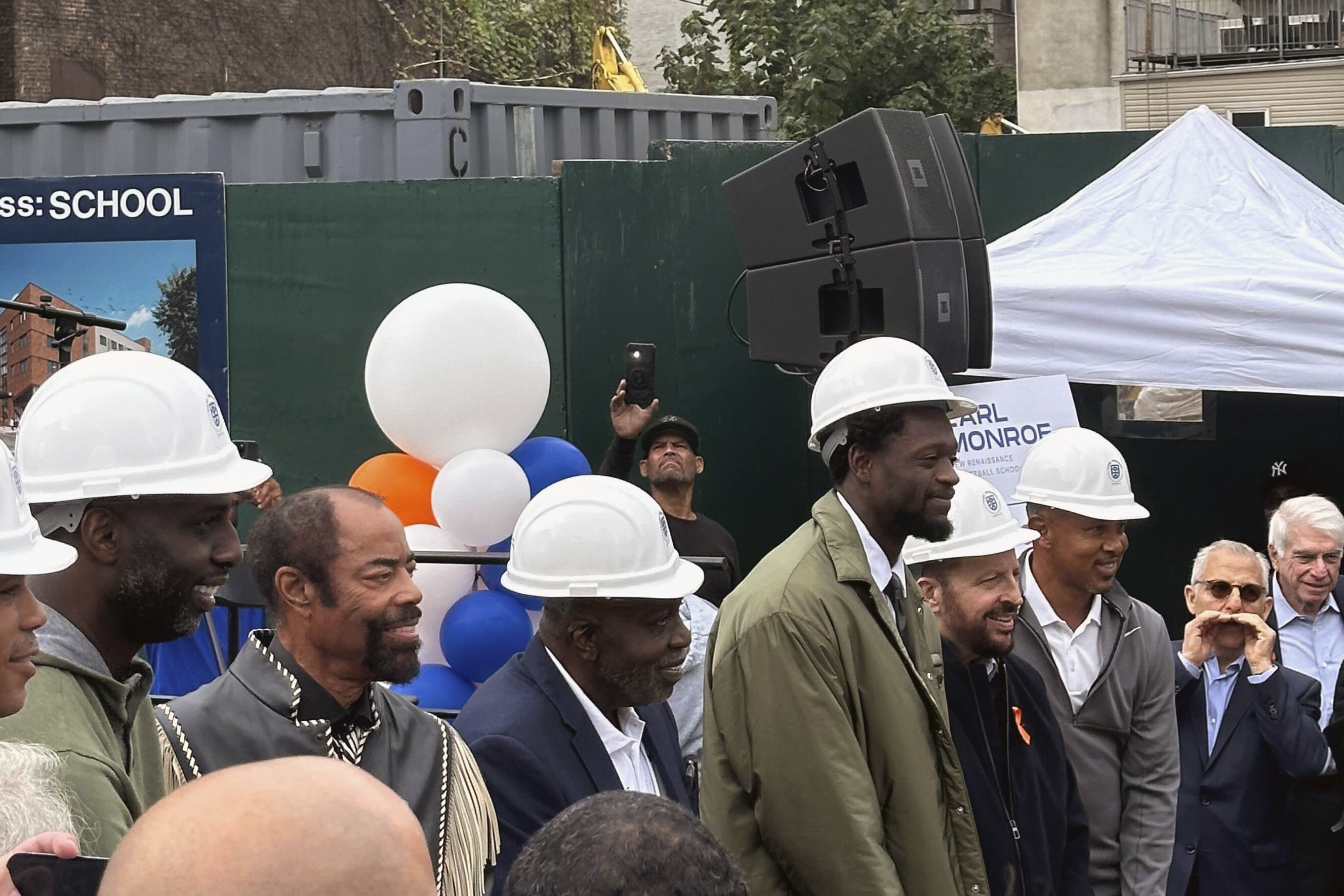 Former New York Knicks basketball players Walt Frazier, second from left without a hard hat, Earl Monroe, center left, Knicks forward Julius Randle, Knicks coach Tom Thibodeau and former Knicks player John Starks attend a groundbreaking ceremony for the Earl Monroe New Renaissance Basketball School, where the basketball court will be named for Randle, Wednesday, Sept. 25, 2024, in New York. 