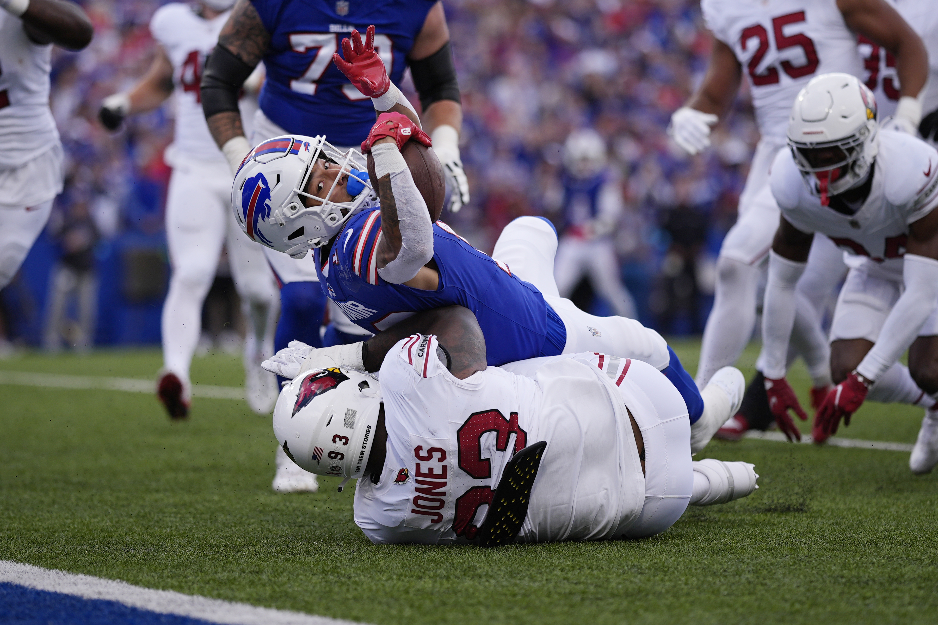 Buffalo Bills wide receiver Khalil Shakir, top, dives for the endzone for a touchdown as Arizona Cardinals defensive tackle Justin Jones is unable to make the tackle during the second half of an NFL football game Sunday, Sept. 8, 2024, in Orchard Park, N.Y. 