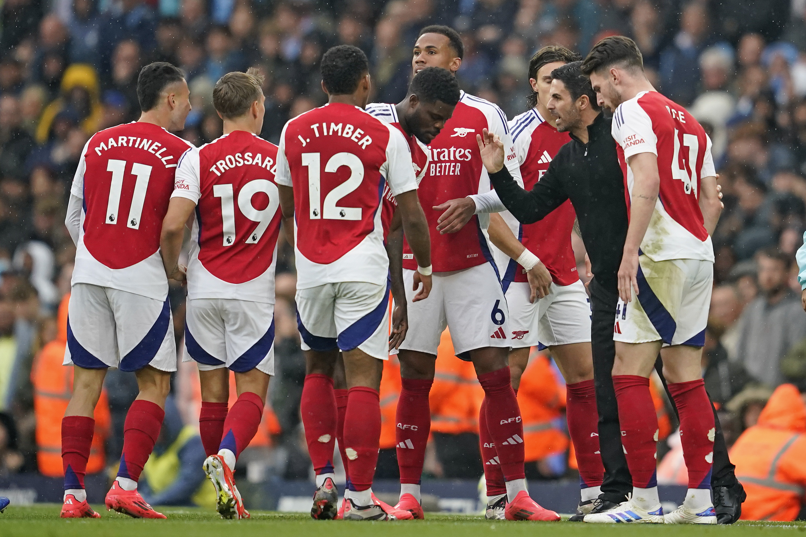 Arsenal's manager Mikel Arteta talks to his players during the English Premier League soccer match between Manchester City and Arsenal at the Etihad stadium in Manchester, England, Sunday, Sept. 22, 2024. 