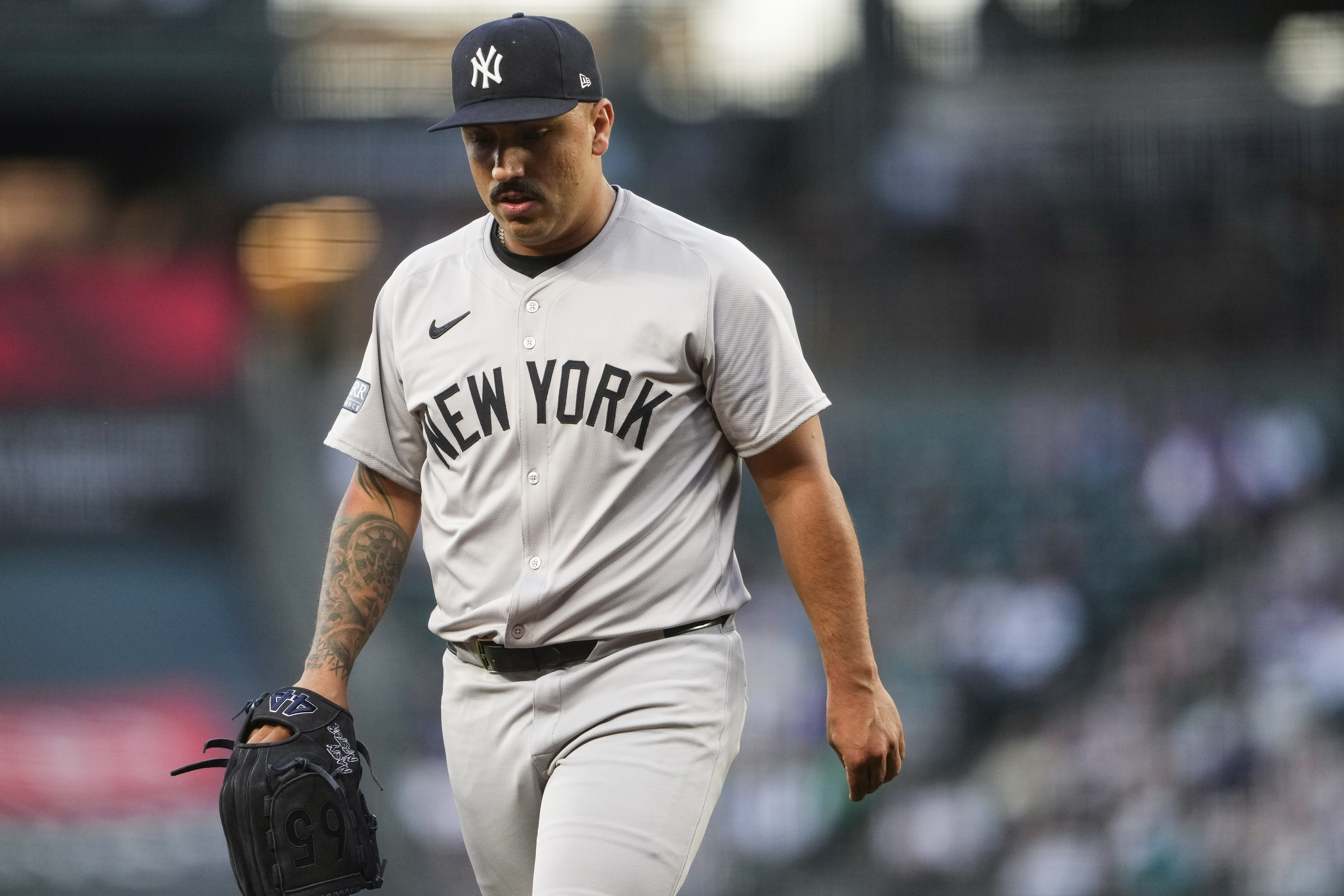New York Yankees starting pitcher Nestor Cortes walks back to the dugout after retiring the side against the Seattle Mariners during the first inning of a baseball game Wednesday, Sept. 18, 2024, in Seattle.