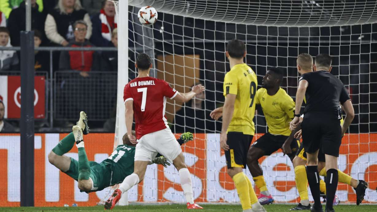 Elfsborg's goalkeeper Isak Pettersson dives but fails to save the goal from AZ Alkmaar's Ruben van Bommel, centre, during the Europa League soccer match between AZ Alkmaar and Elfsborg at the AFAS stadium, in Alkmaar, Netherlands, Wednesday, Oct. 25, 2024.